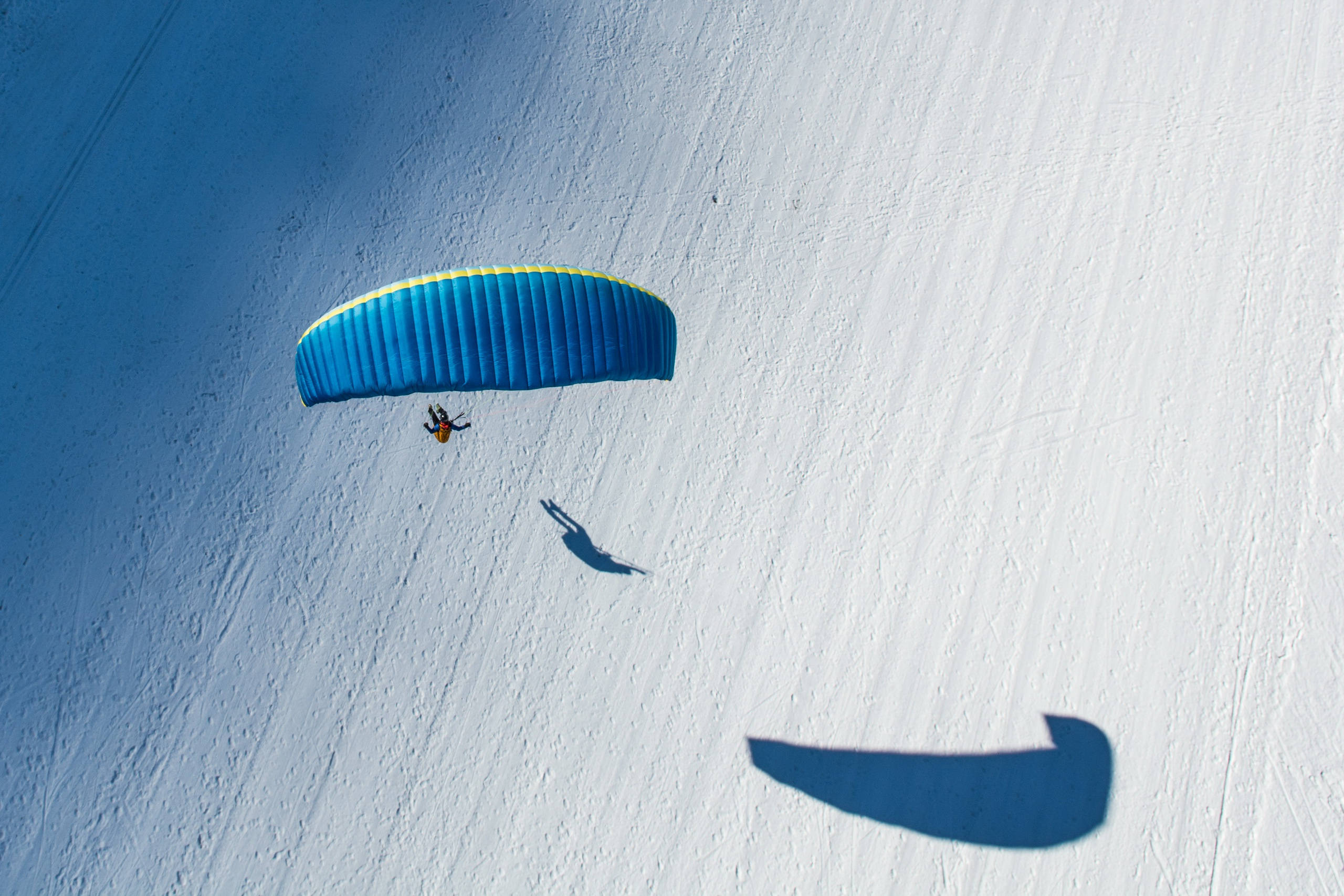 paragliding, blue canopy, snowy slope, 2K Desktop Wallpaper
