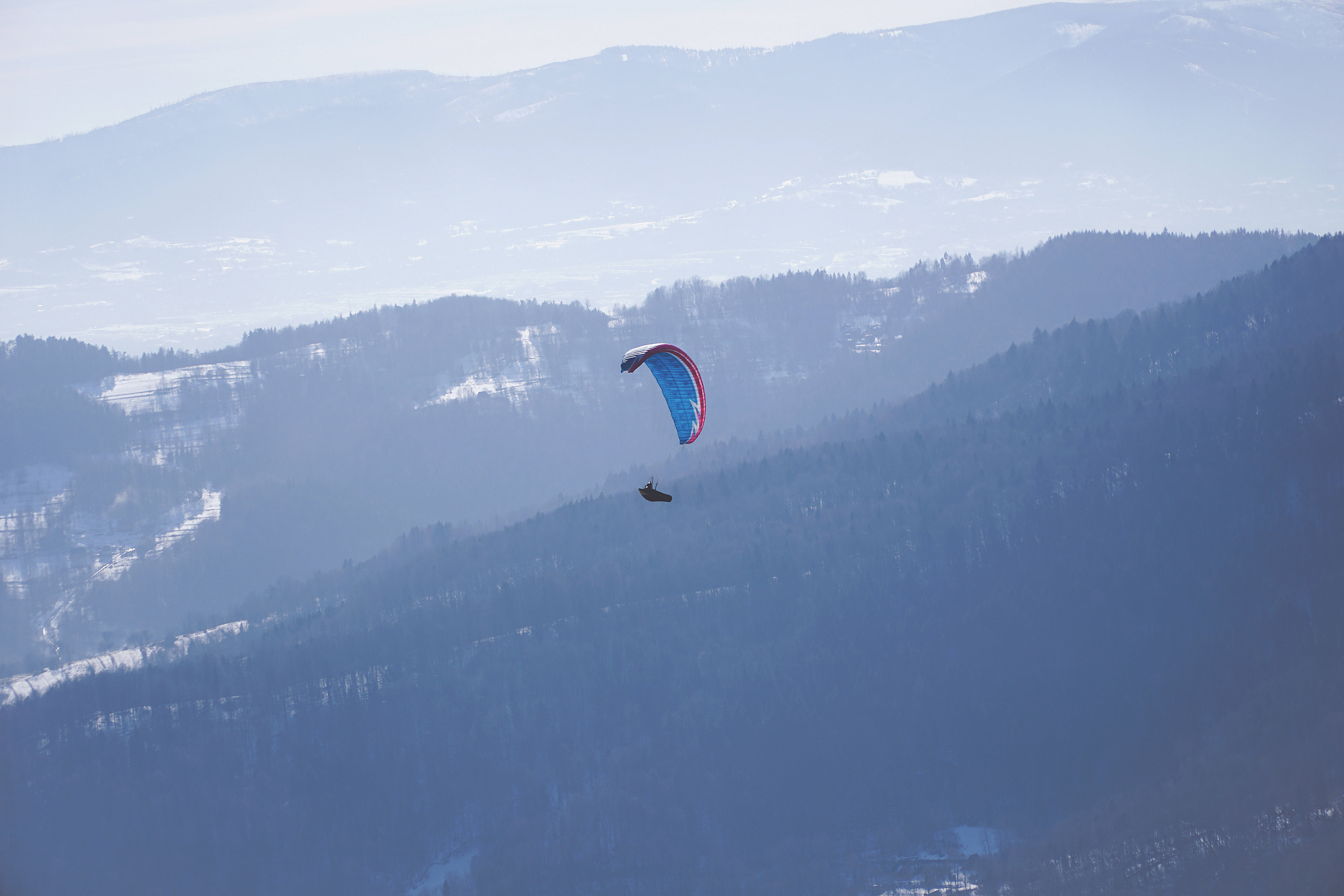 paragliding, blue and red canopy, snow-dusted mountains, 5K Desktop Wallpaper
