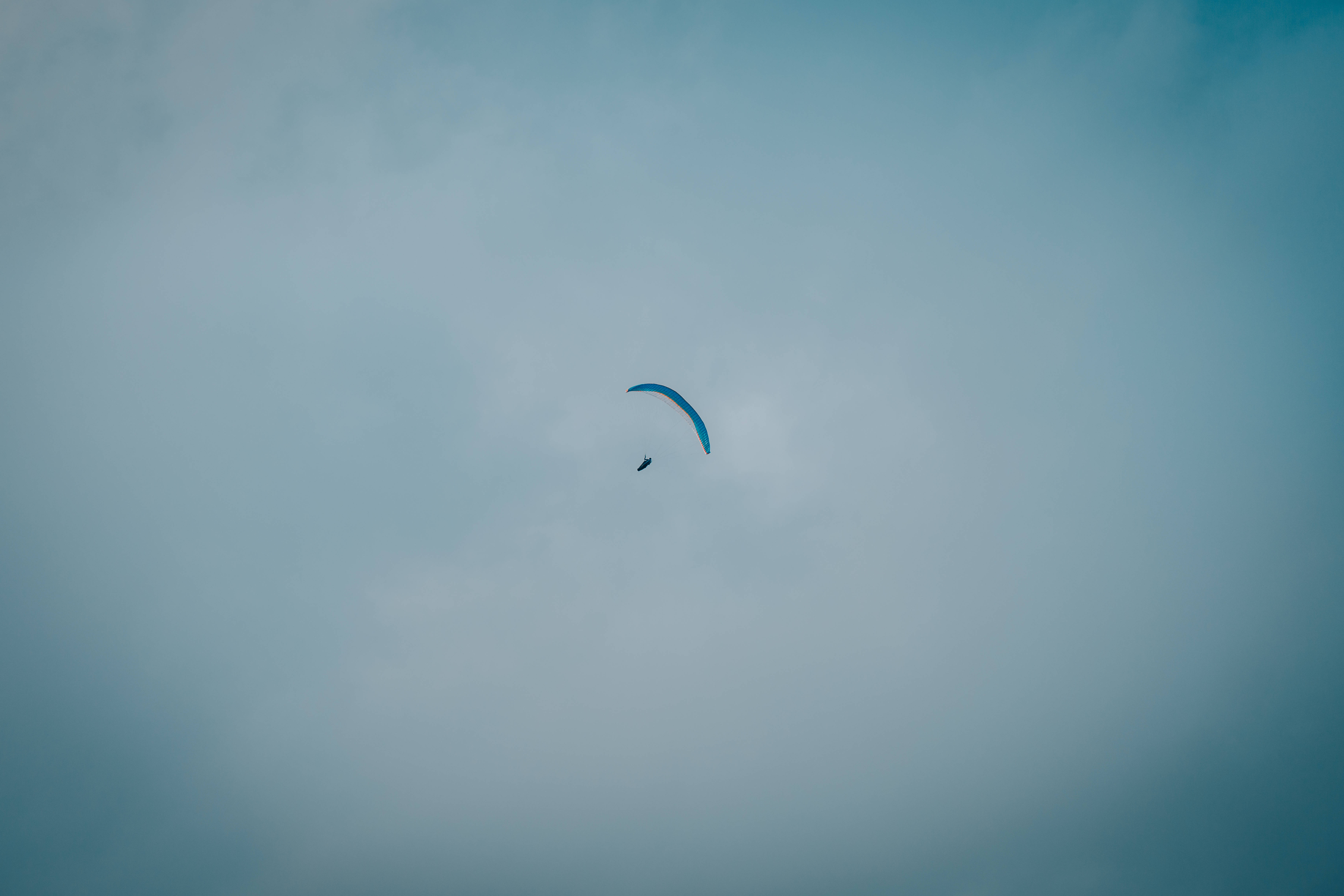 paragliding, blue paraglider, overcast sky, 5K Desktop Wallpaper
