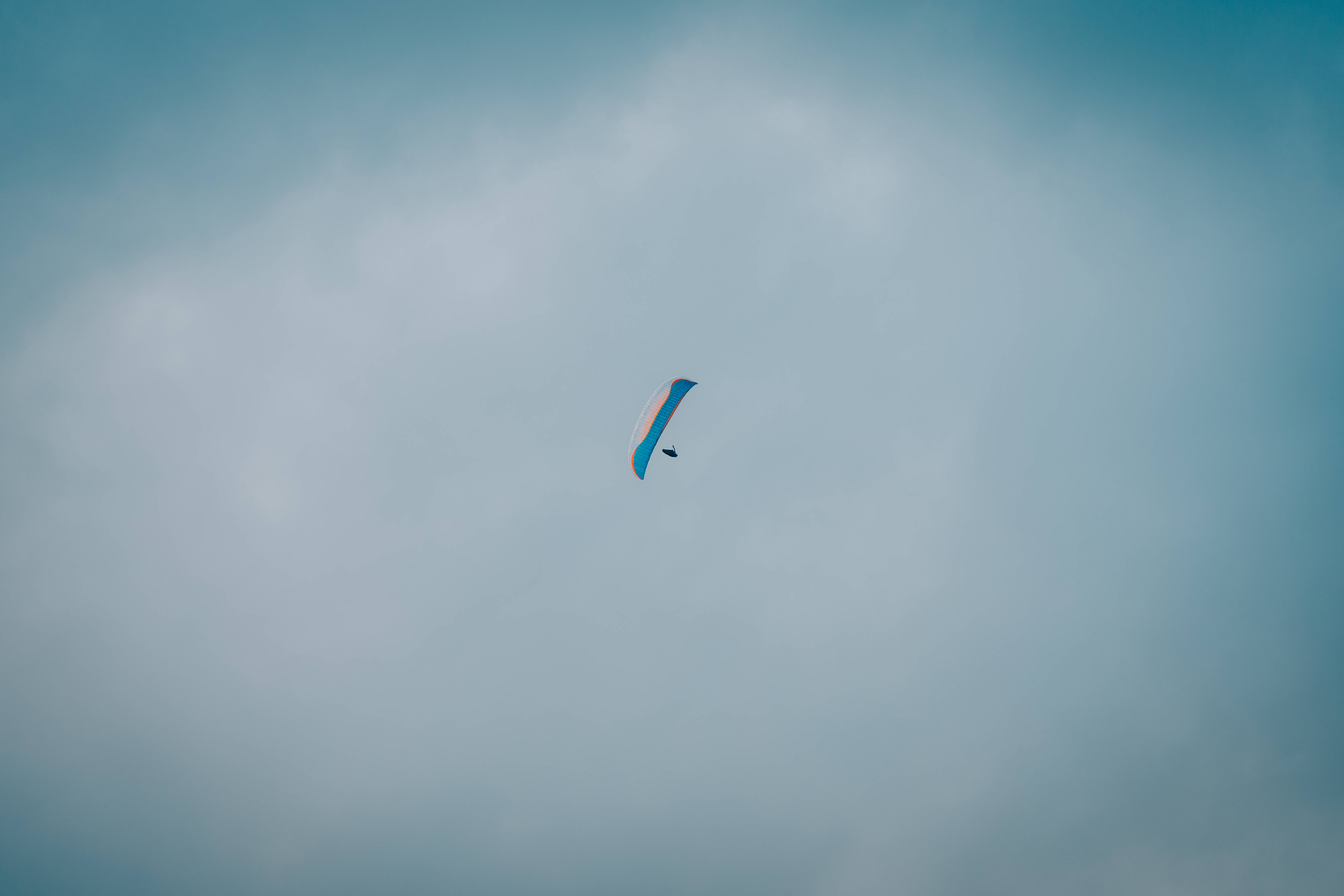 paragliding, blue and white paraglider, overcast sky, 5K Desktop Wallpaper