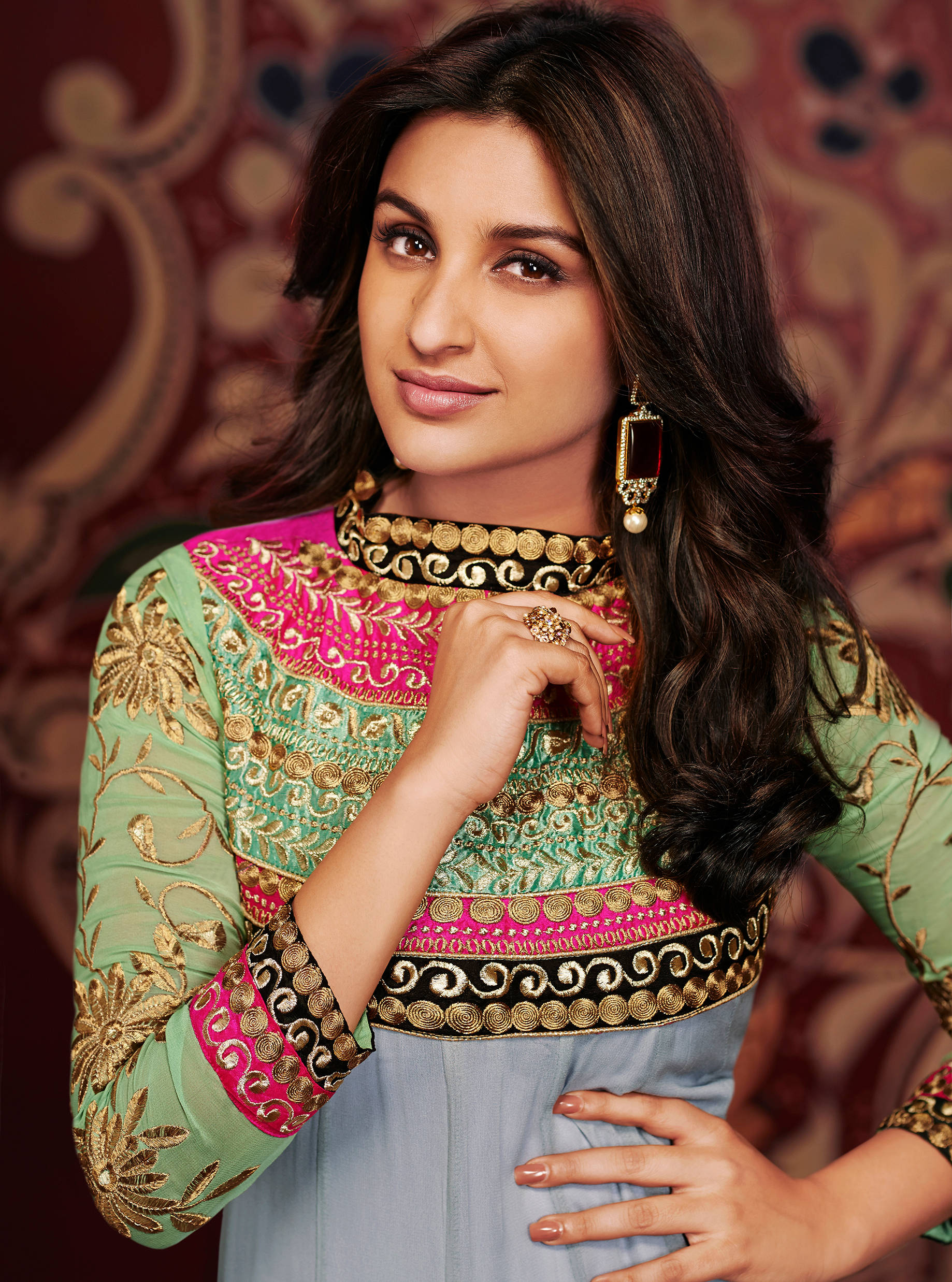 Parineeti Chopra, vibrant green and pink embroidered outfit, richly patterned red backdrop, Full HD Phone Wallpaper