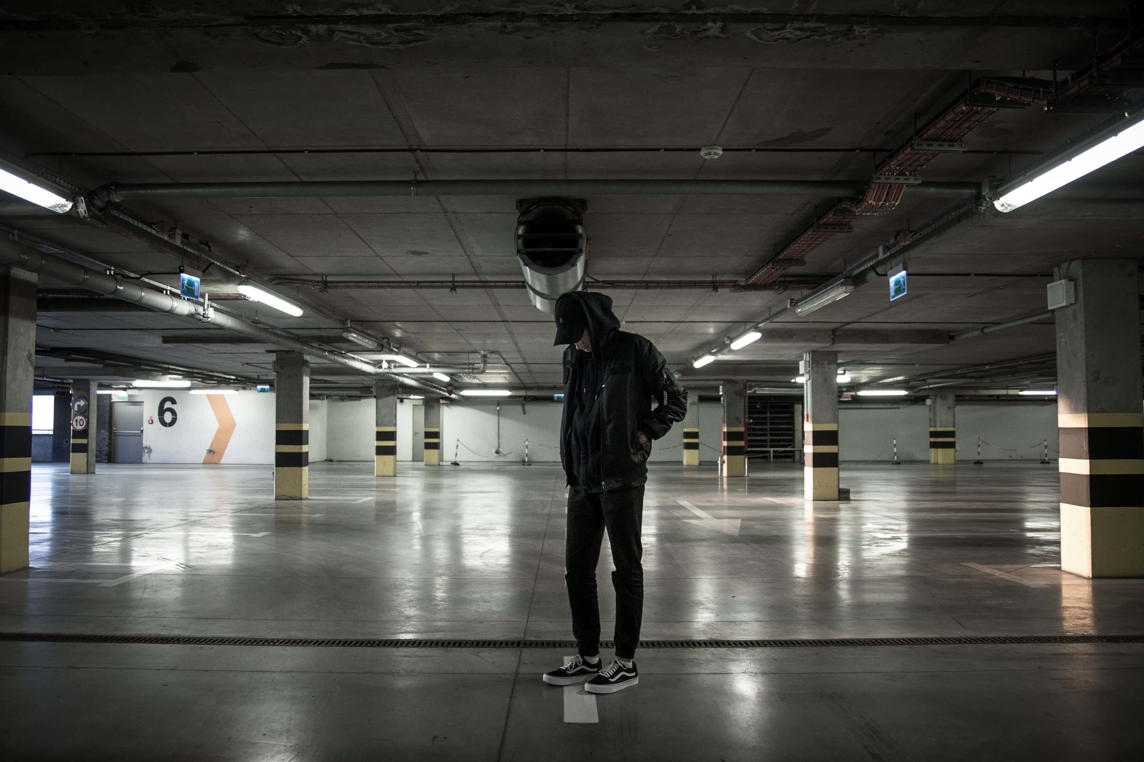 underground parking lot, hooded figure, dimly lit, 4K Desktop Wallpaper