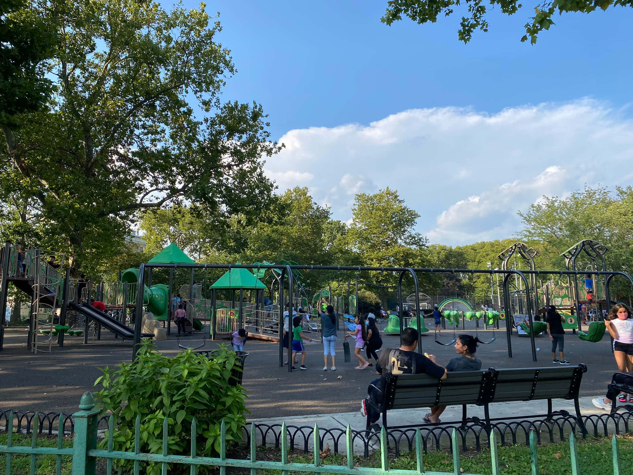 Community Park Playground, green and black playground equipment, bright blue sky, Full HD Desktop Wallpaper