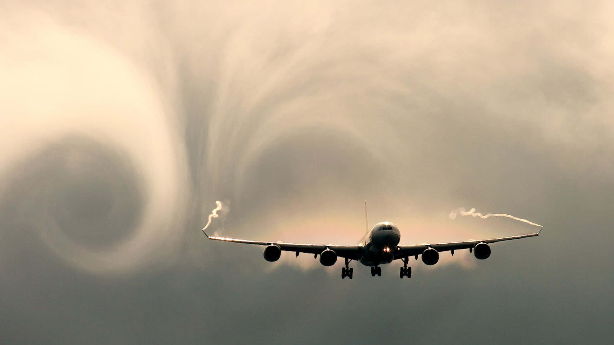 commercial airplane, dramatic sky, swirling cloud formations, 2K Desktop Wallpaper