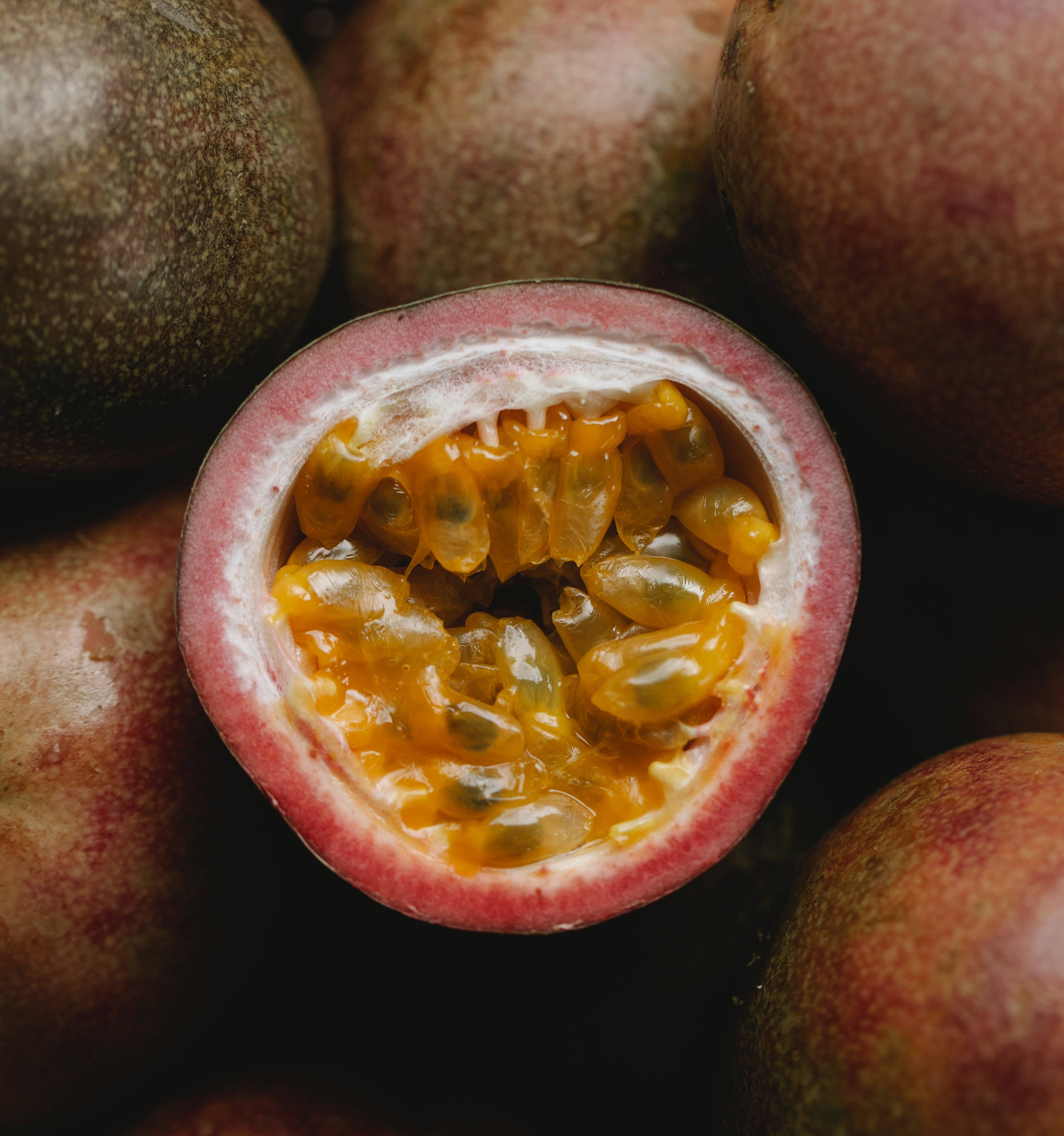 half passion fruit, glistening golden pulp, seeds, 2K Phone Wallpaper