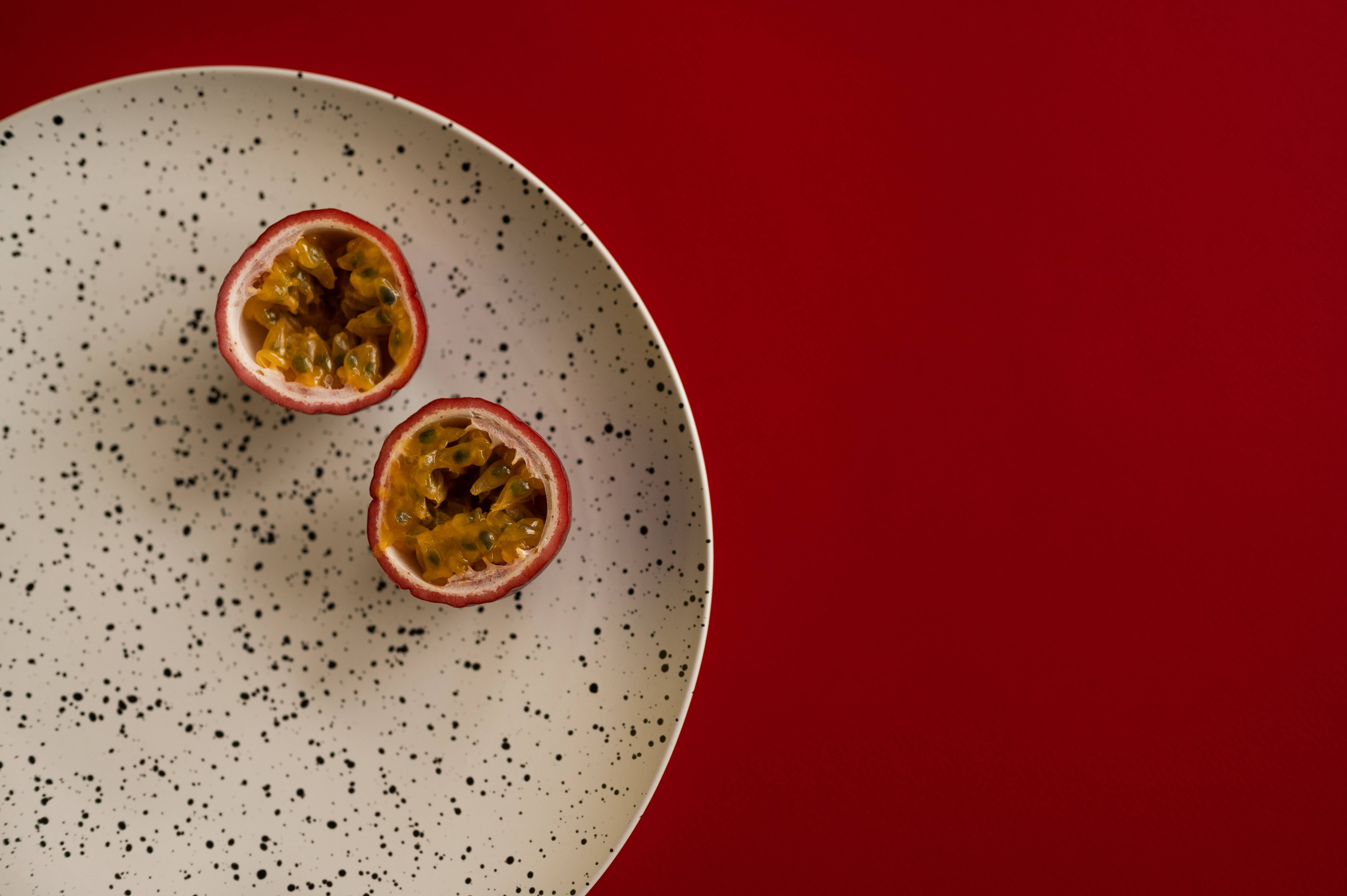 passion fruit, speckled plate, bold red background, 5K Desktop Wallpaper