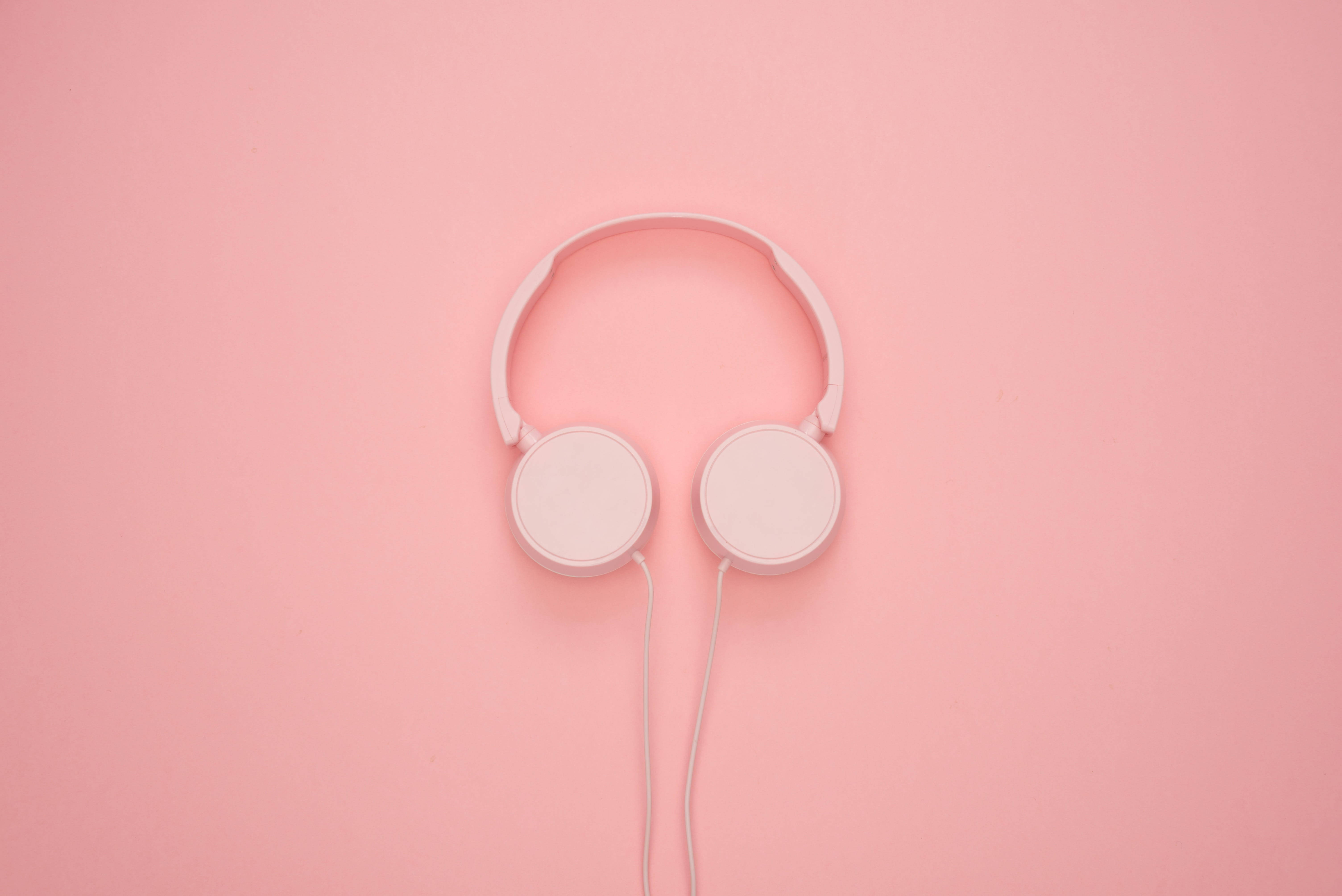 pink headphones, pastel pink background, minimalist white over-ear headphones, 5K Desktop Wallpaper