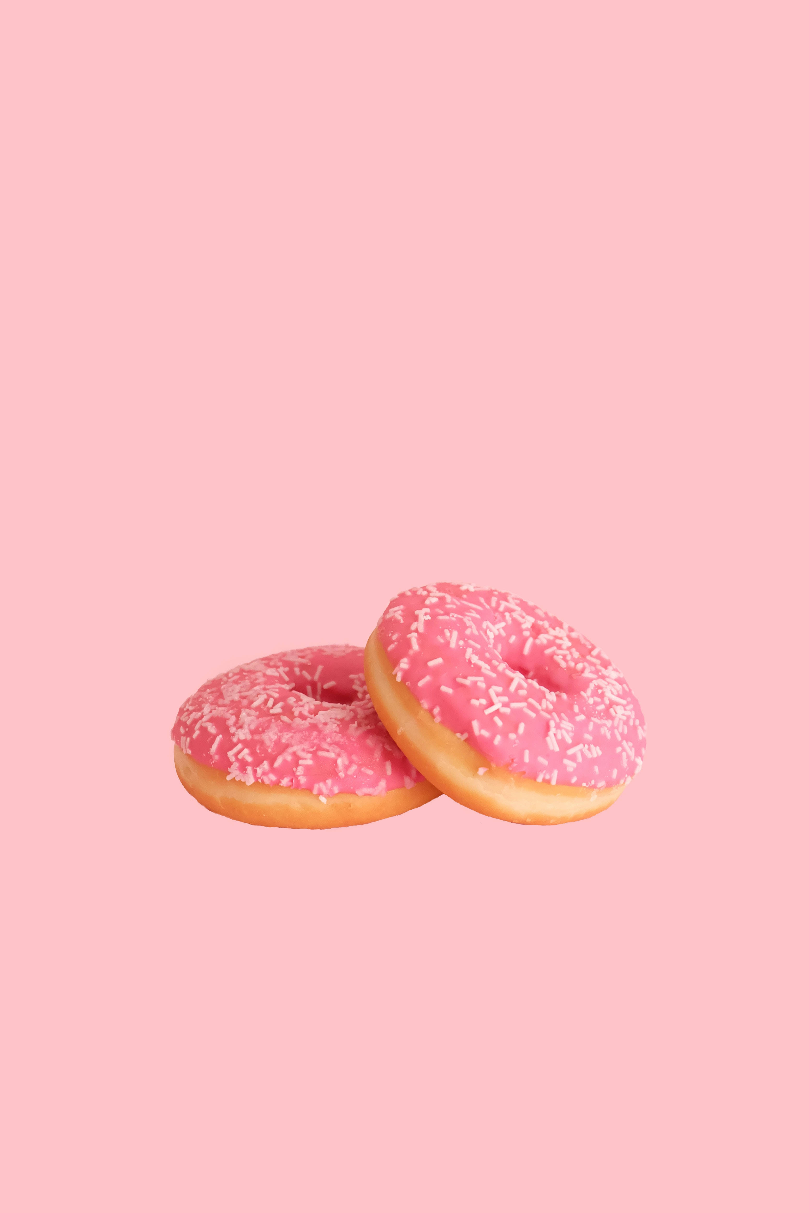 Pastel iPhone, pink-frosted donuts, white sprinkles, 4K Phone Wallpaper