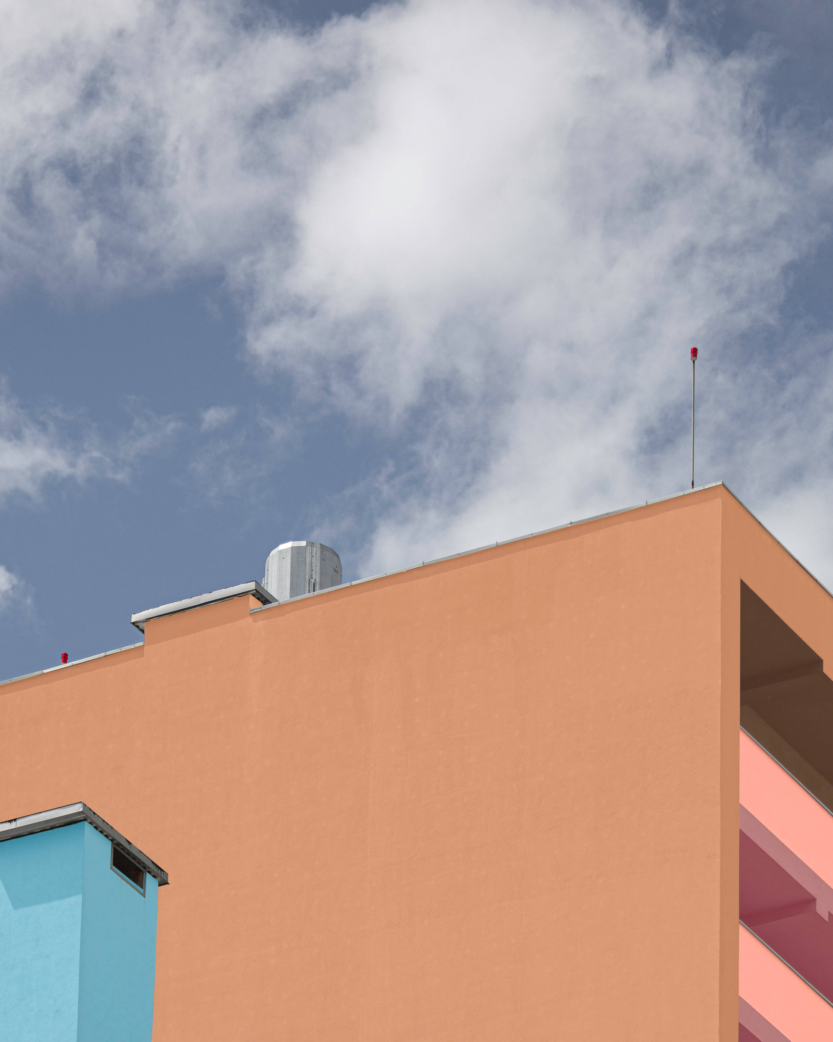 pastel orange aesthetic wall, peach building, blue accent, 2K Phone Wallpaper