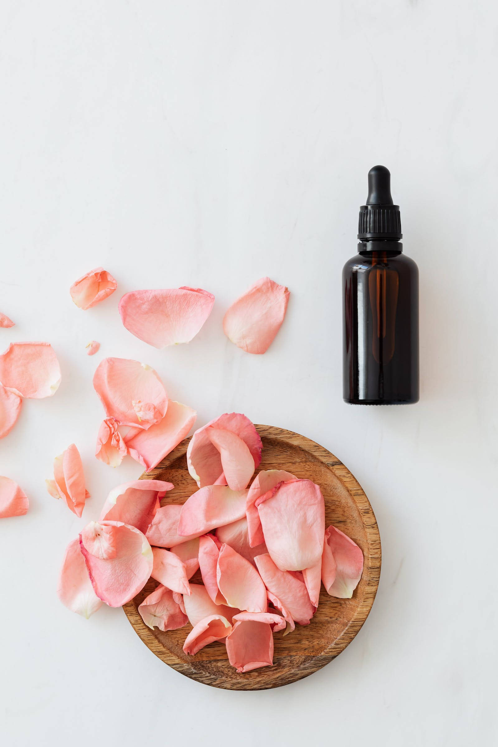 pastel pink color petals, wooden bowl, dark amber dropper bottle, Full HD Phone Wallpaper