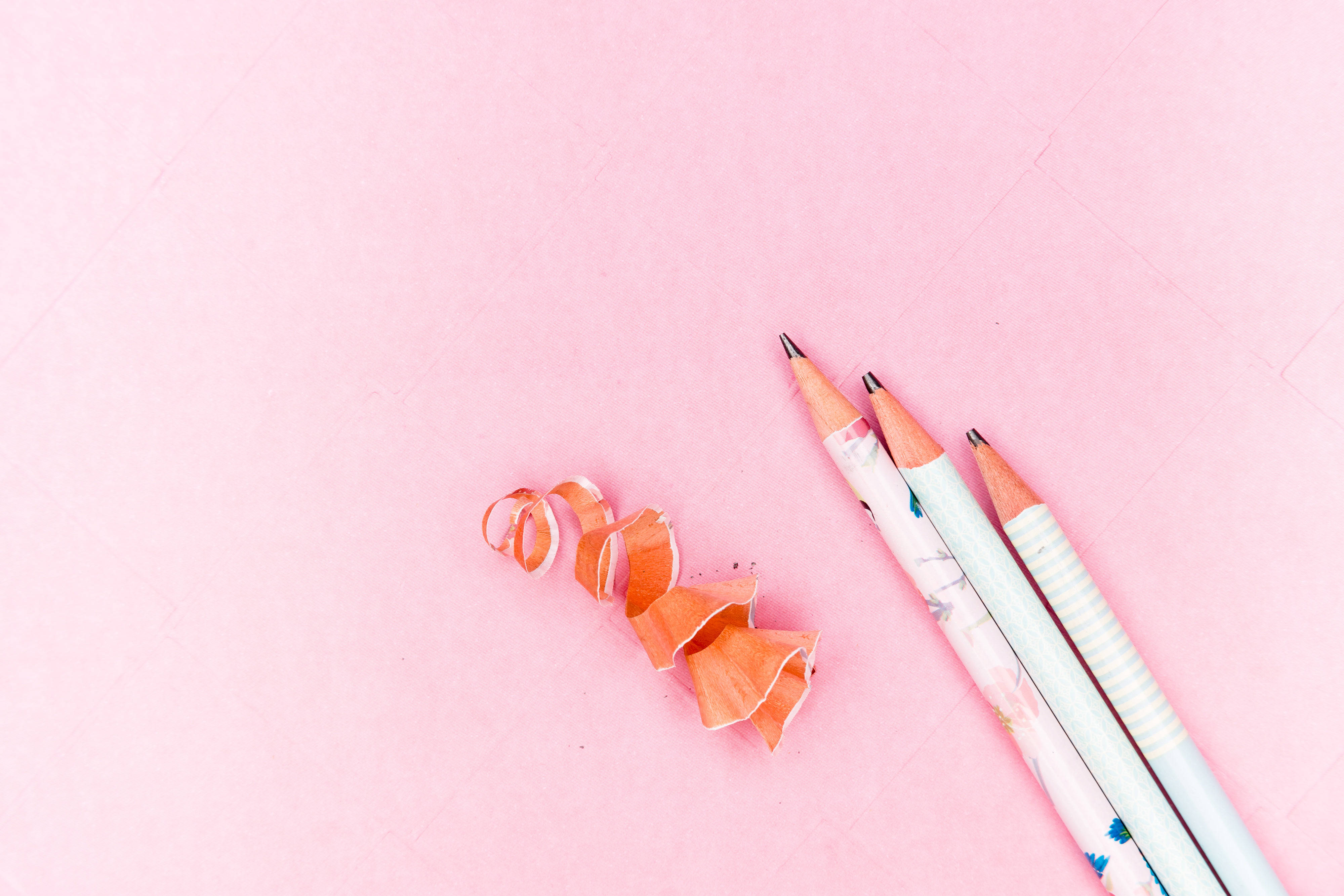 pastel pink color paper, soft pink textured surface, orange shavings, 4K Desktop Wallpaper