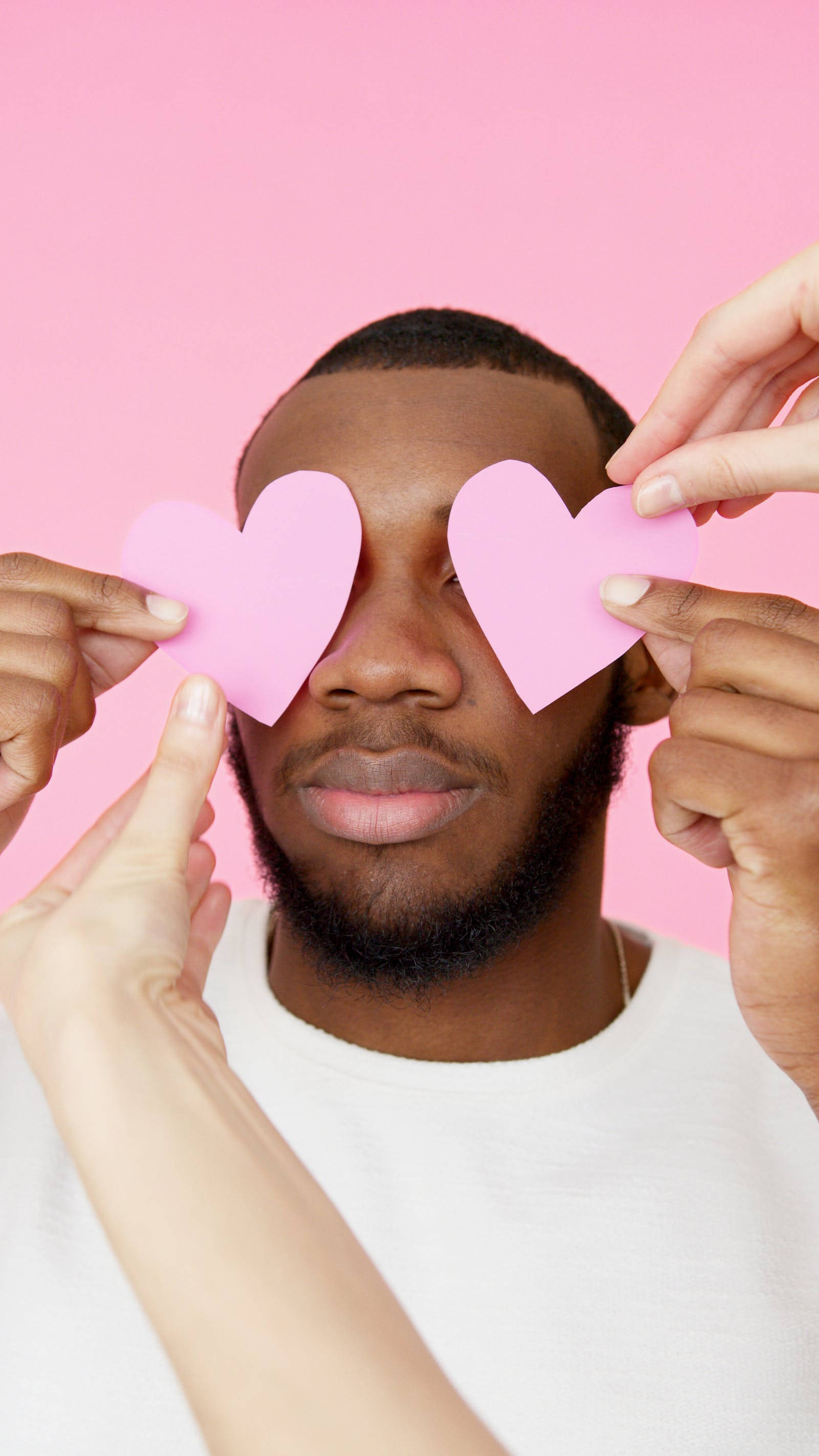 pastel pink heart cutouts, man with dark skin, pink paper hearts, 2K Phone Wallpaper