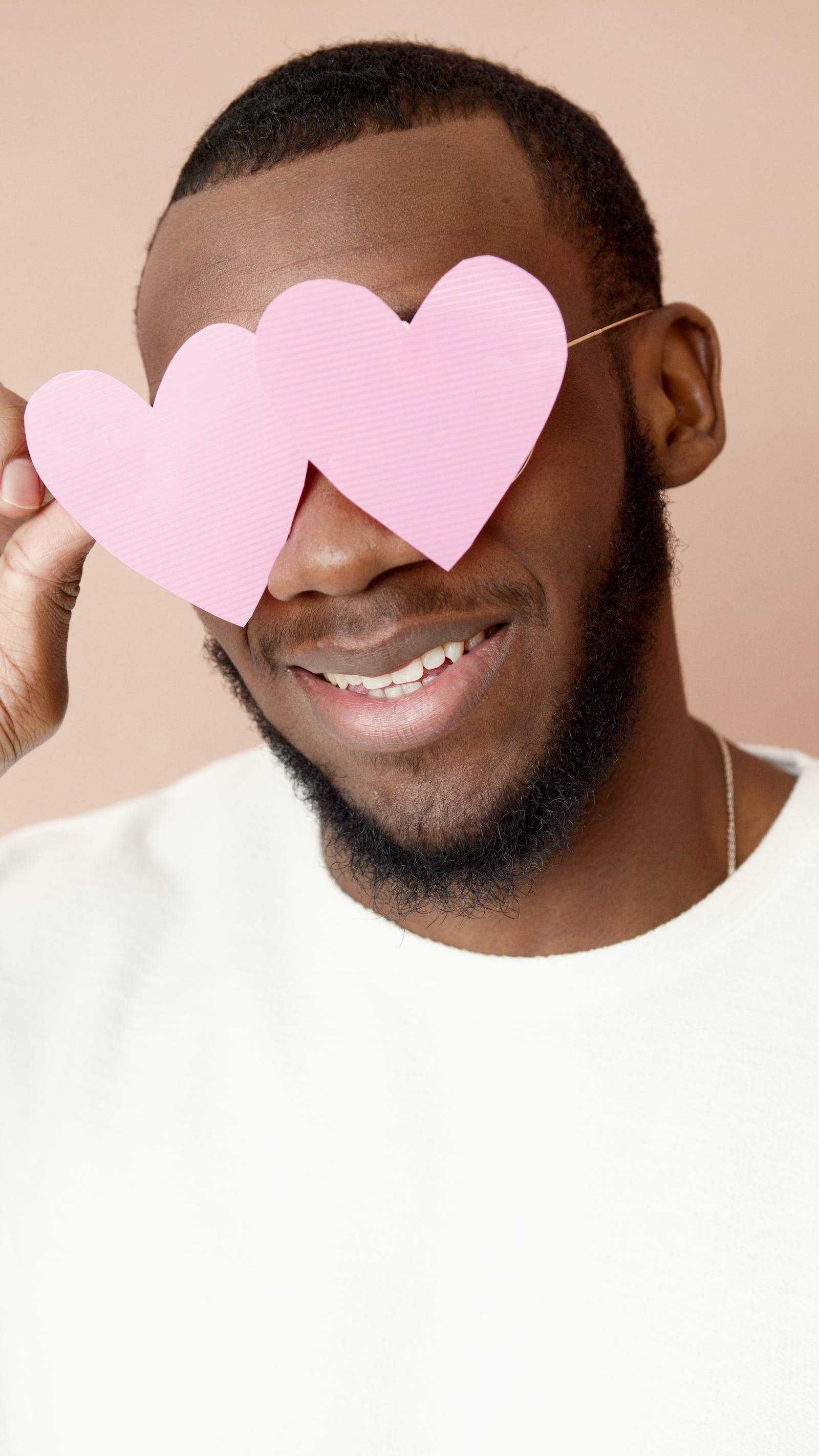 pastel pink heart, man smiling, pink heart-shaped cutouts, 2K Phone Wallpaper