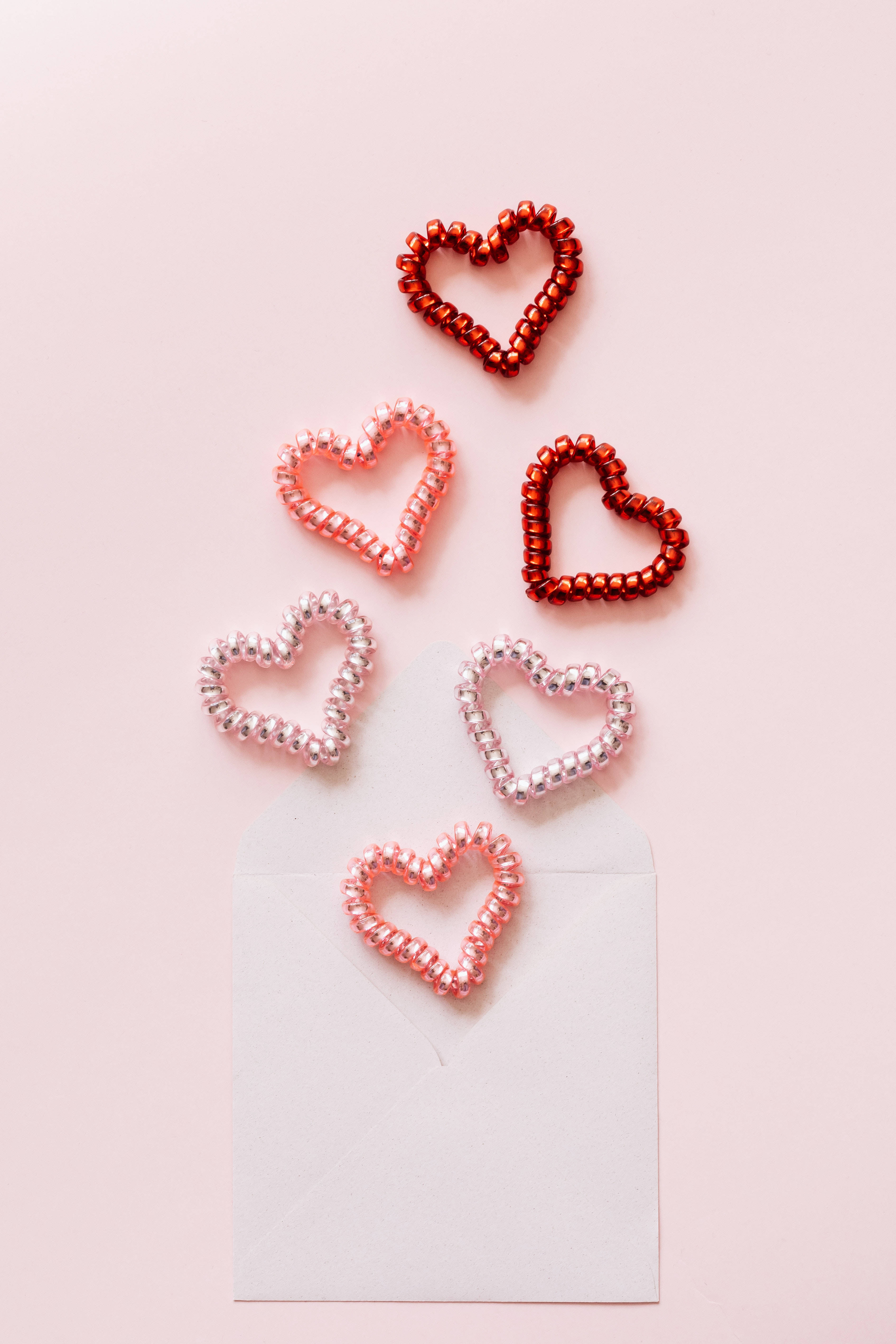 Spiral Pastel Pink Heart Hair Ties, red and pink hues, white envelope, 5K Phone Wallpaper