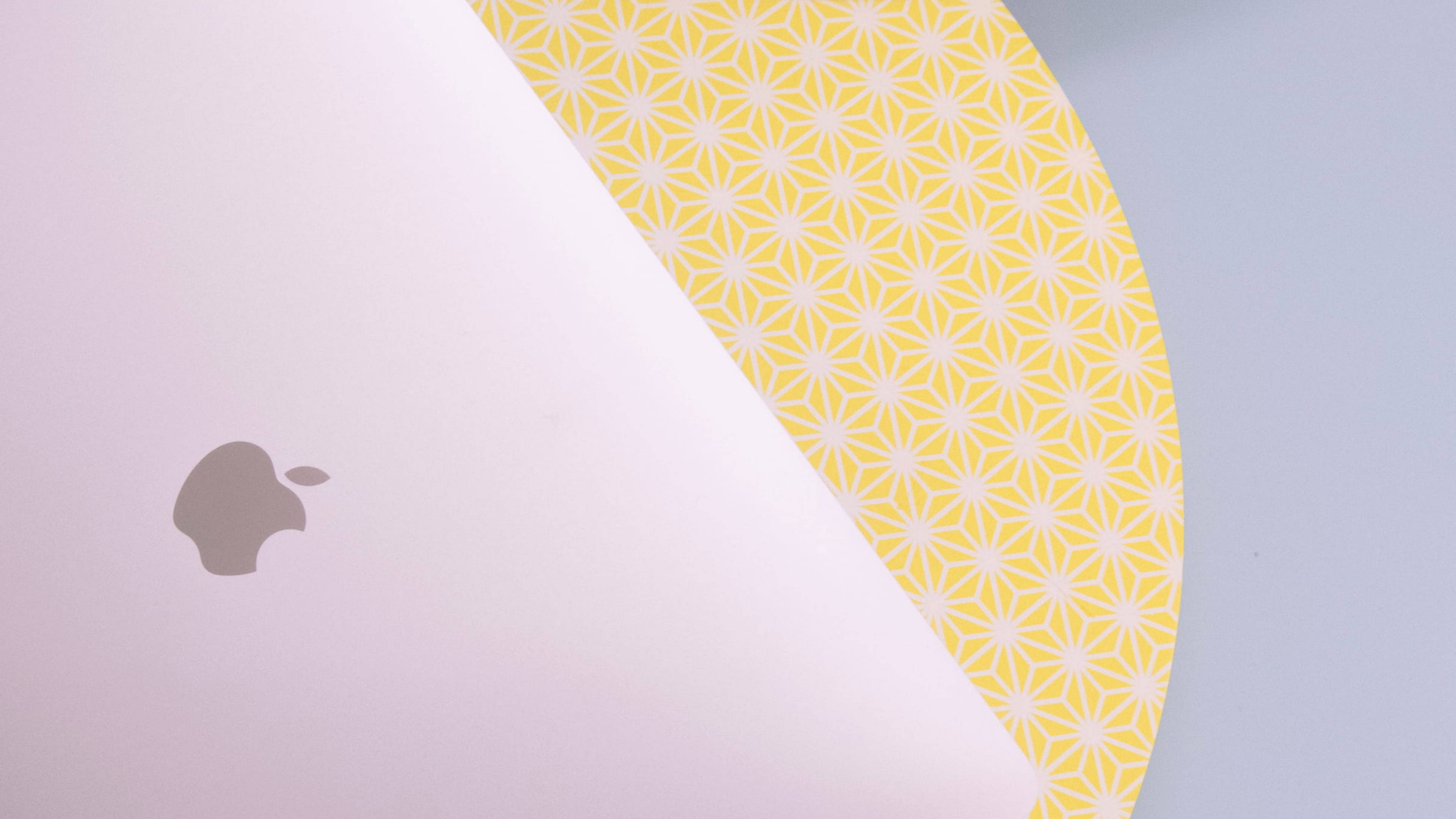 light purple laptop lid, yellow geometric patterned paper, partially peeled back, 4K Desktop Wallpaper