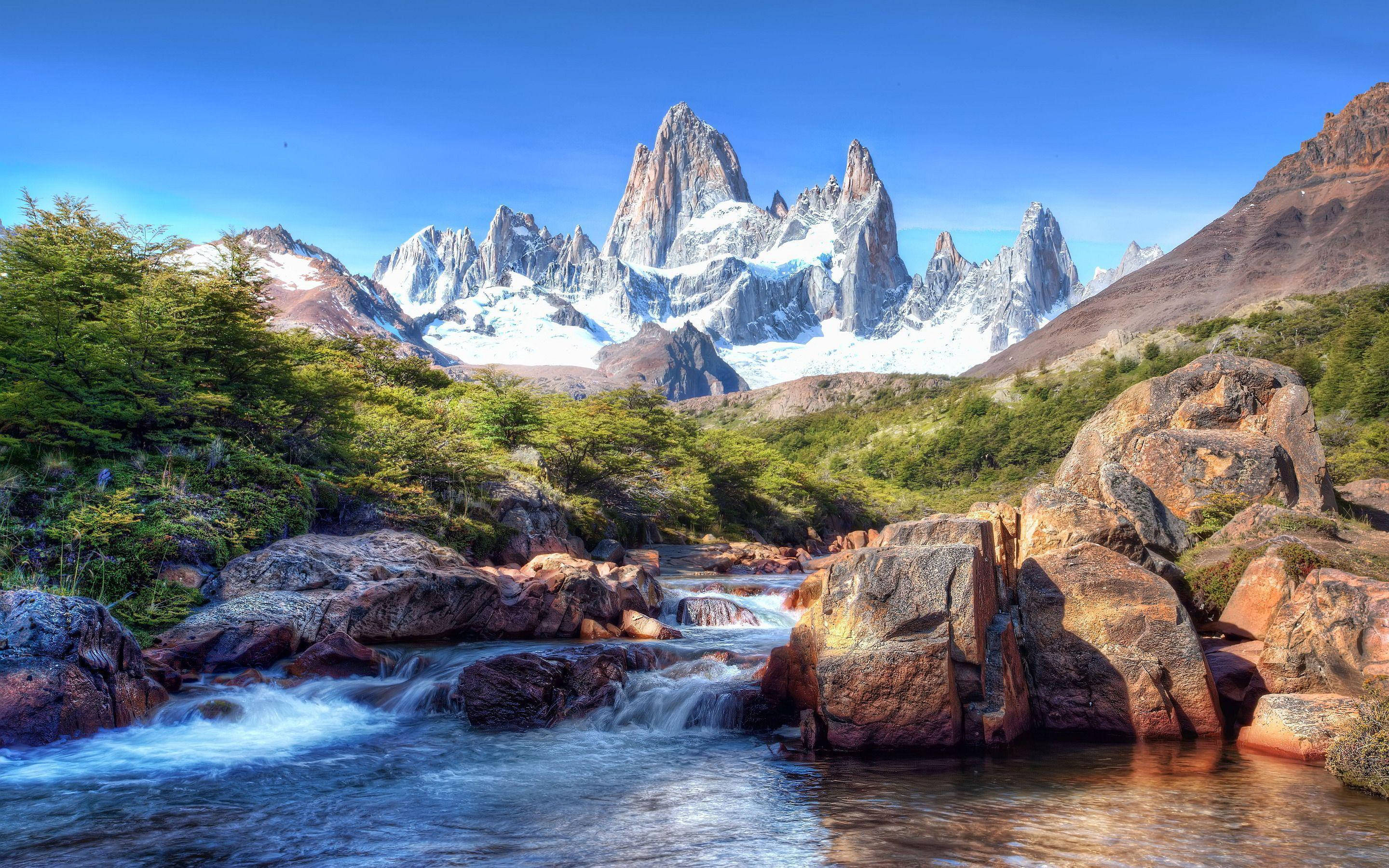 Patagonia, cascading river water, reddish rocks, 2K Desktop Wallpaper