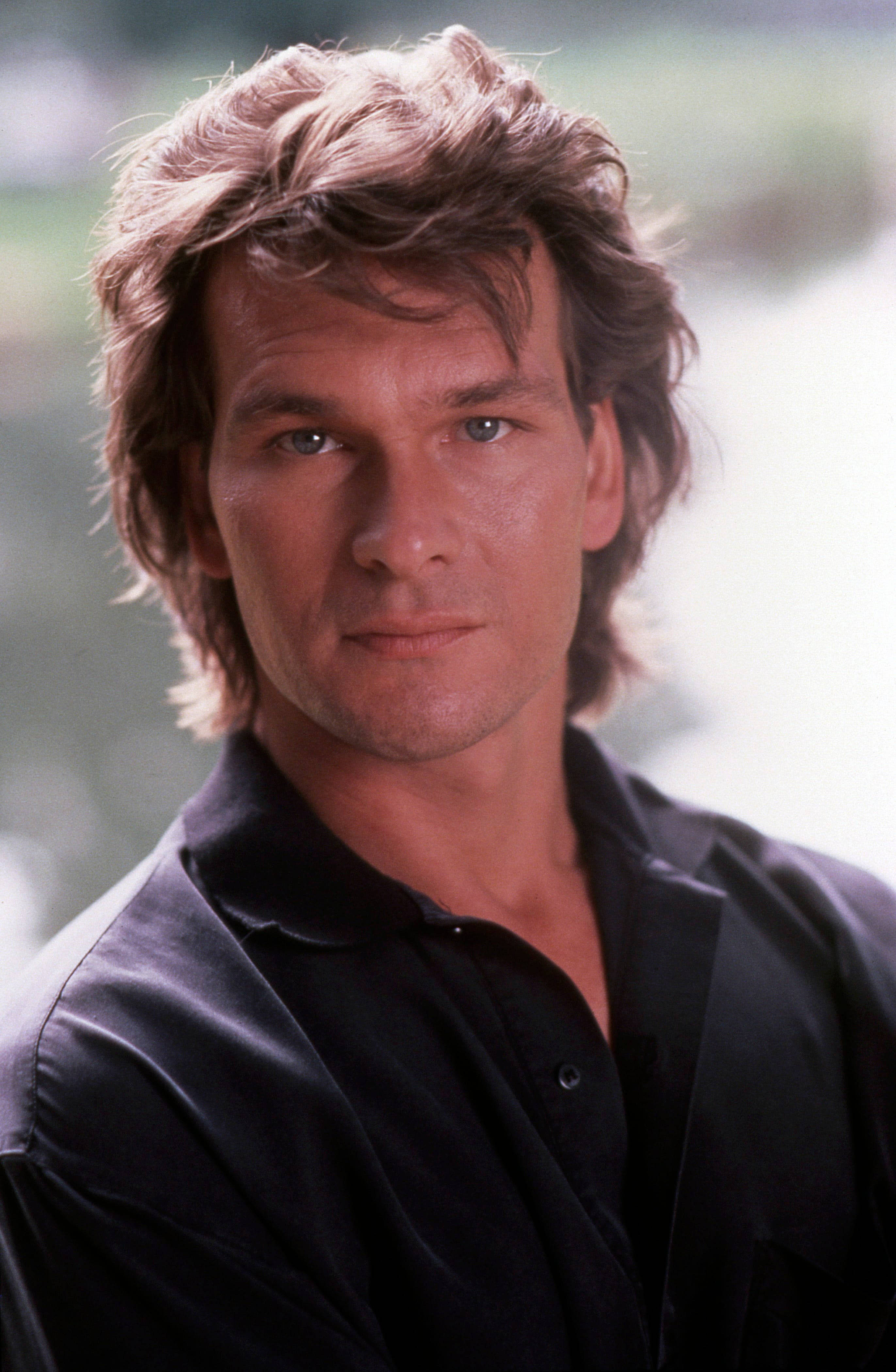 Patrick Swayze, black shirt, tousled brown hair, 4K Phone Wallpaper