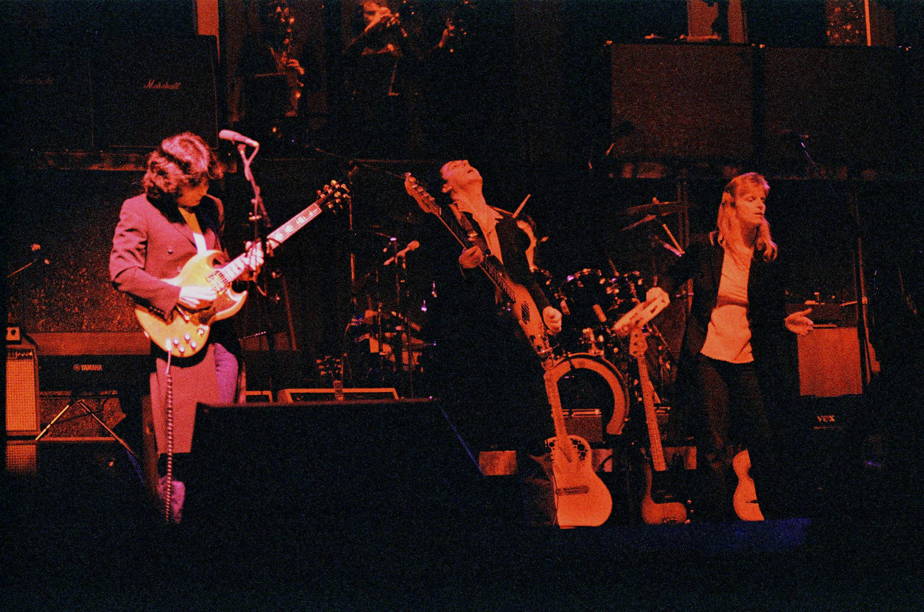 Paul McCartney And Wings, live on stage, dimly lit stage, 2K Desktop Wallpaper