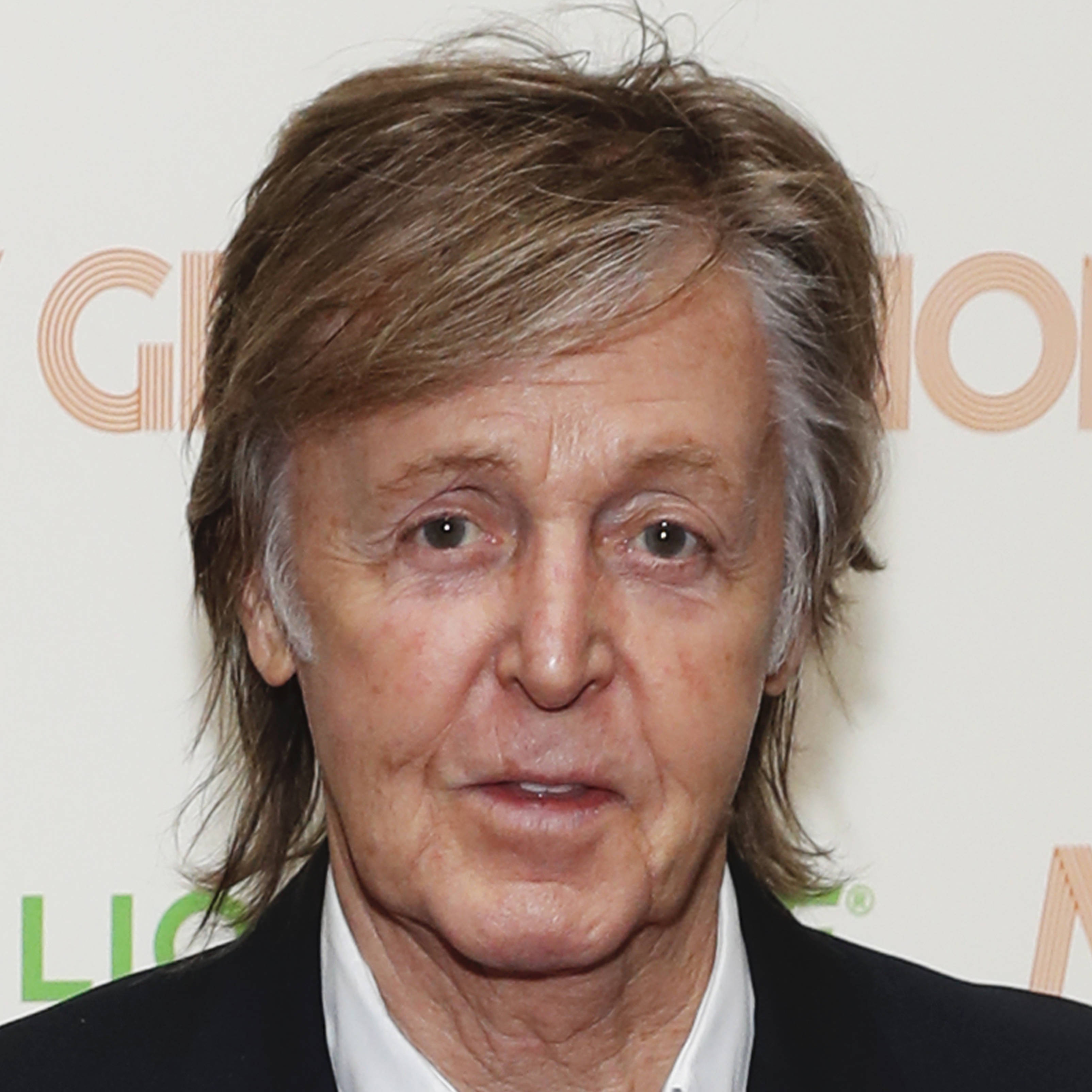 Paul McCartney, tousled brown hair, serious expression, 2K Desktop Wallpaper