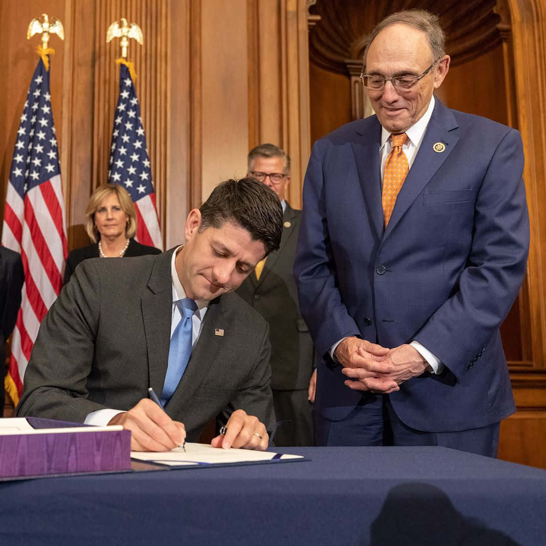 Paul Ryan, wood-paneled room, American flags, SD Desktop Wallpaper