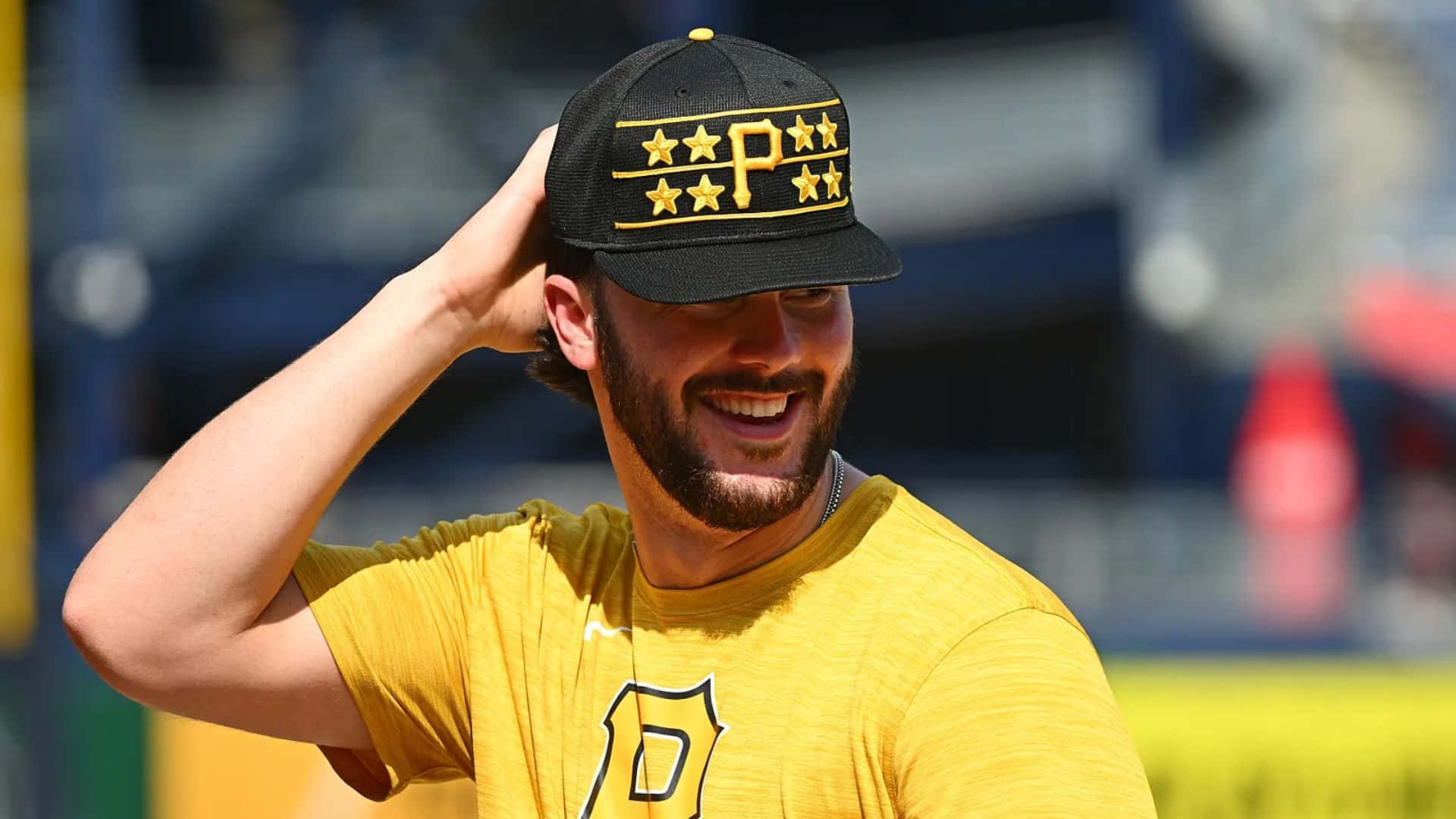 Paul Skenes, yellow jersey, black cap with gold stars, Full HD Desktop Wallpaper