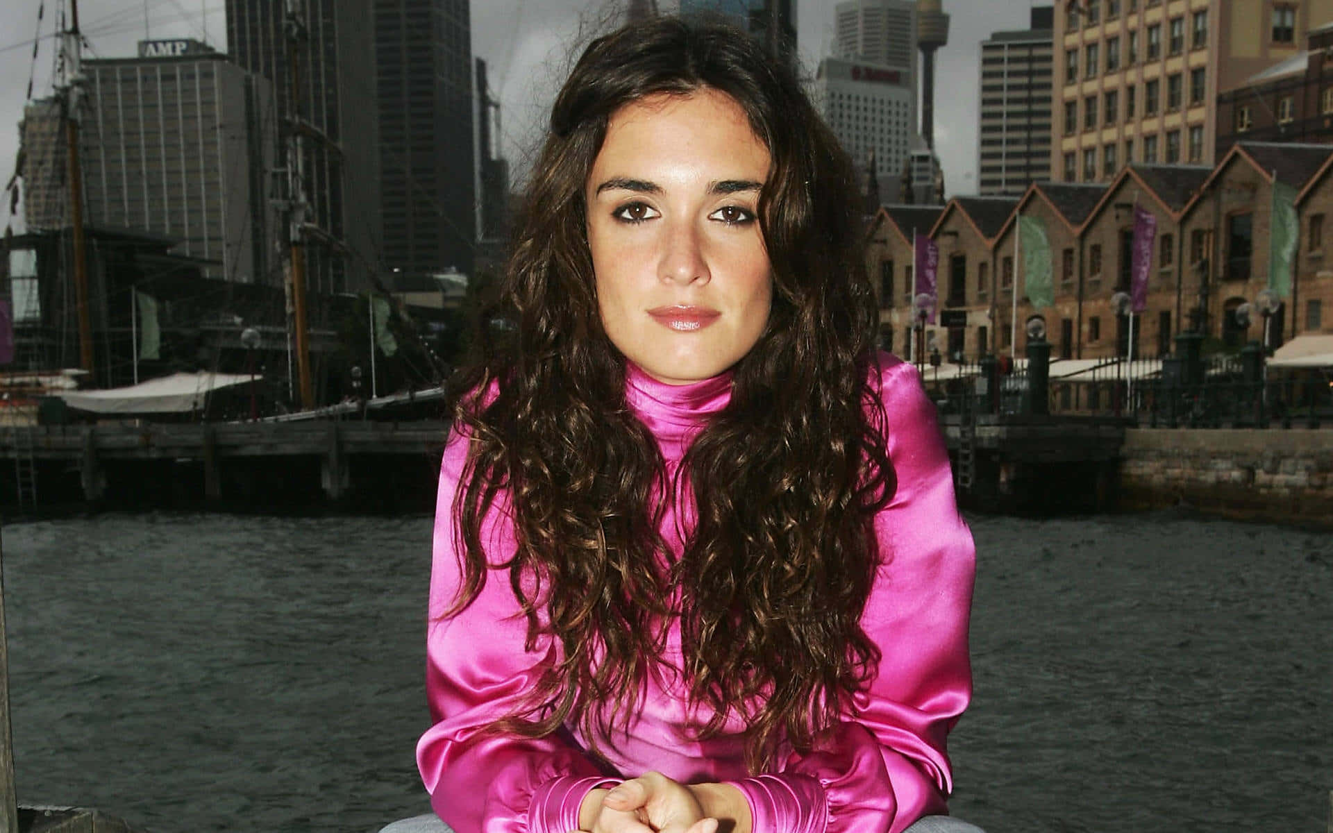 Paz Vega, vibrant pink satin top, city skyline, Full HD Desktop Wallpaper
