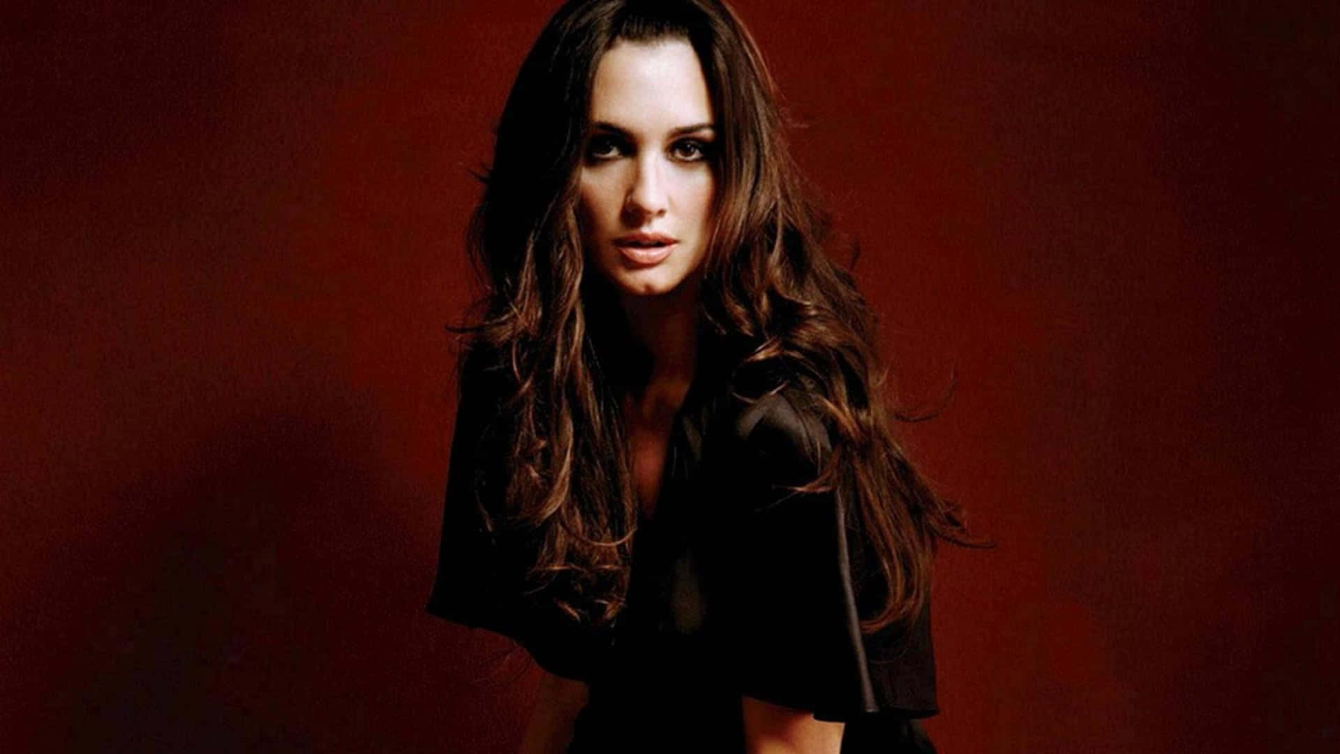 Paz Vega, deep red studio backdrop, black top, Full HD Desktop Wallpaper