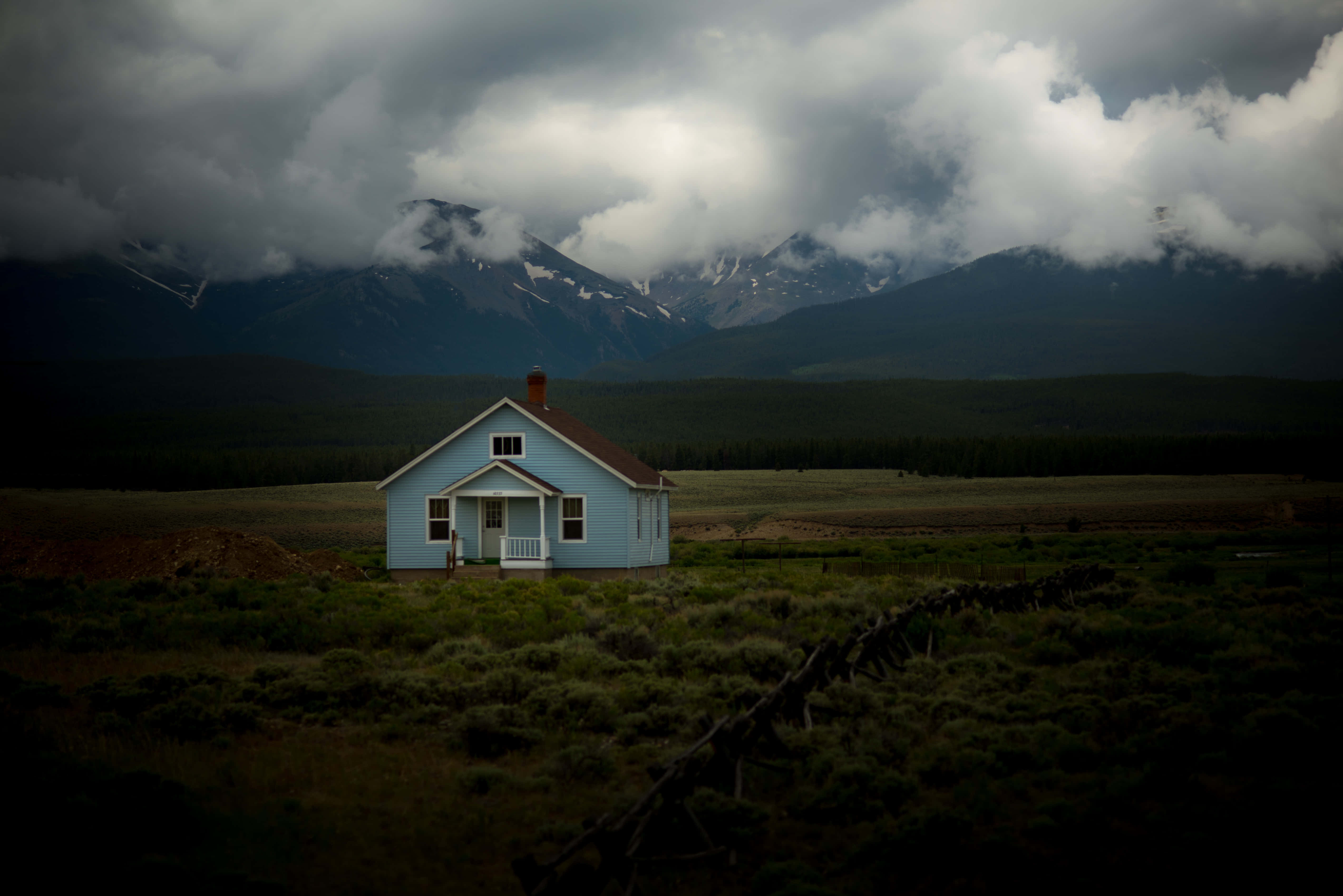 light blue house, vast field, dramatic cloudy sky, 5K Desktop Wallpaper