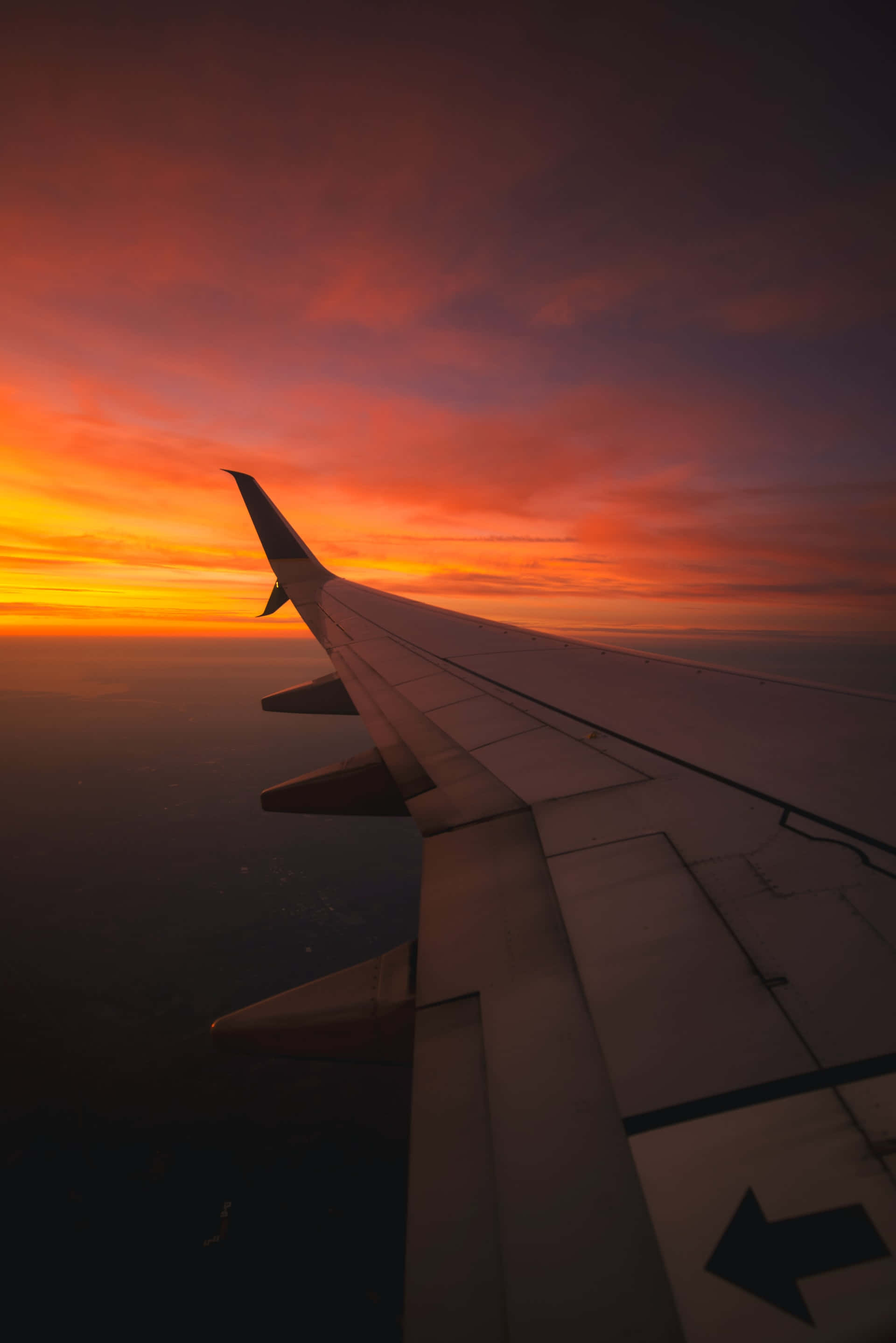 aircraft wing, fiery orange and red sunset, dark earth horizon, 2K Phone Wallpaper