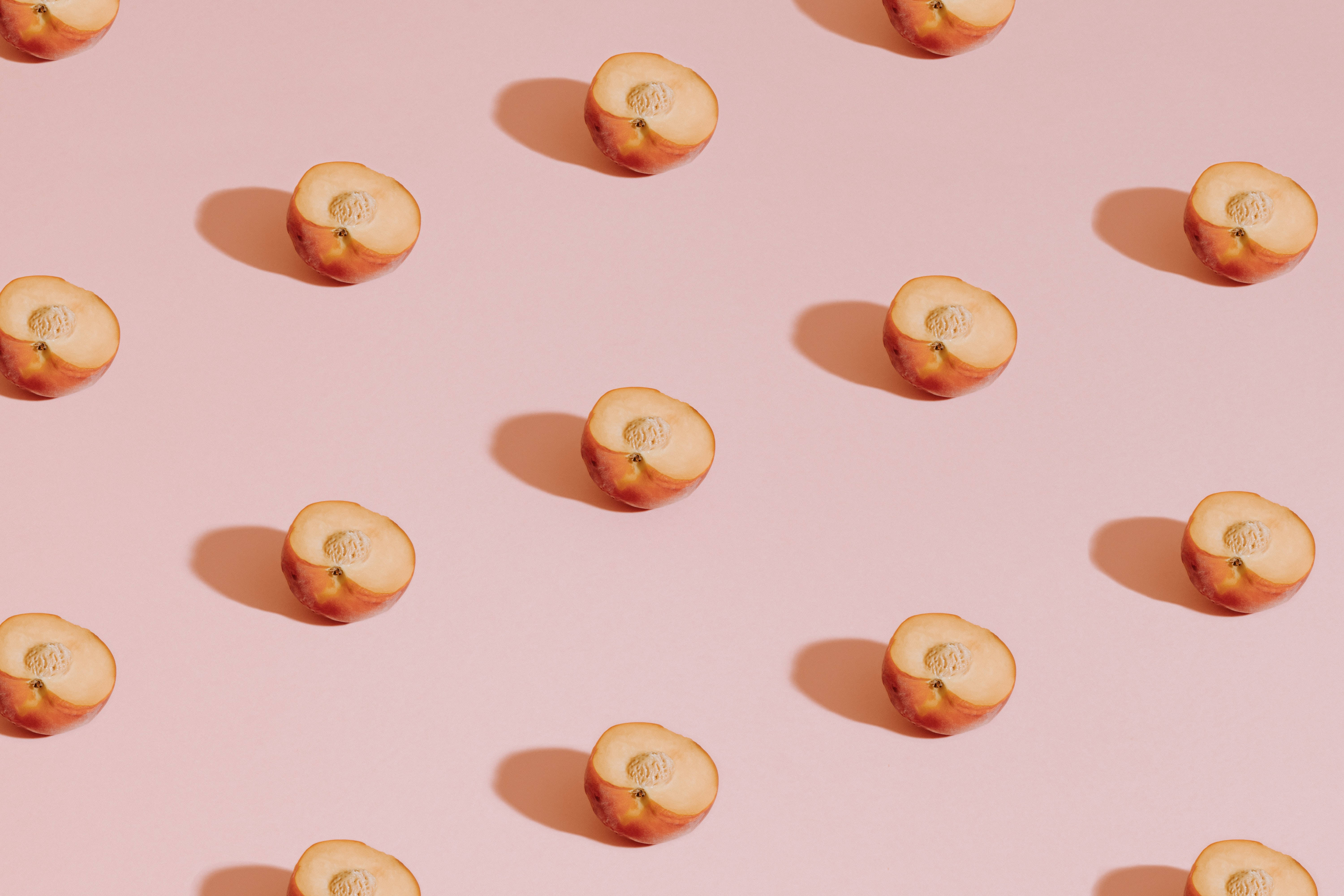 peach slices, soft pink background, scattered pattern, 5K Desktop Wallpaper
