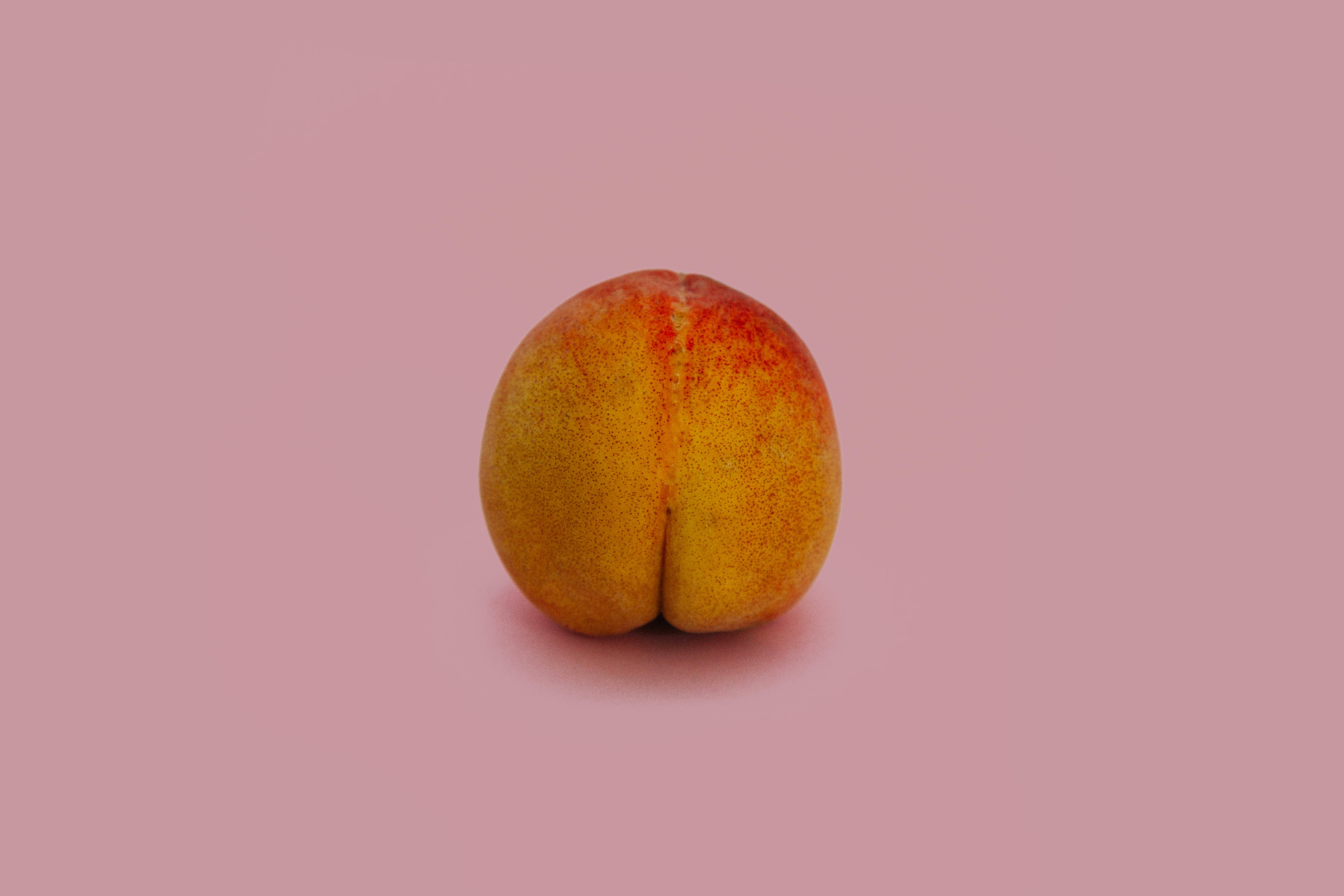 peach, fuzzy yellow and red skin, solid pink background, 5K Desktop Wallpaper