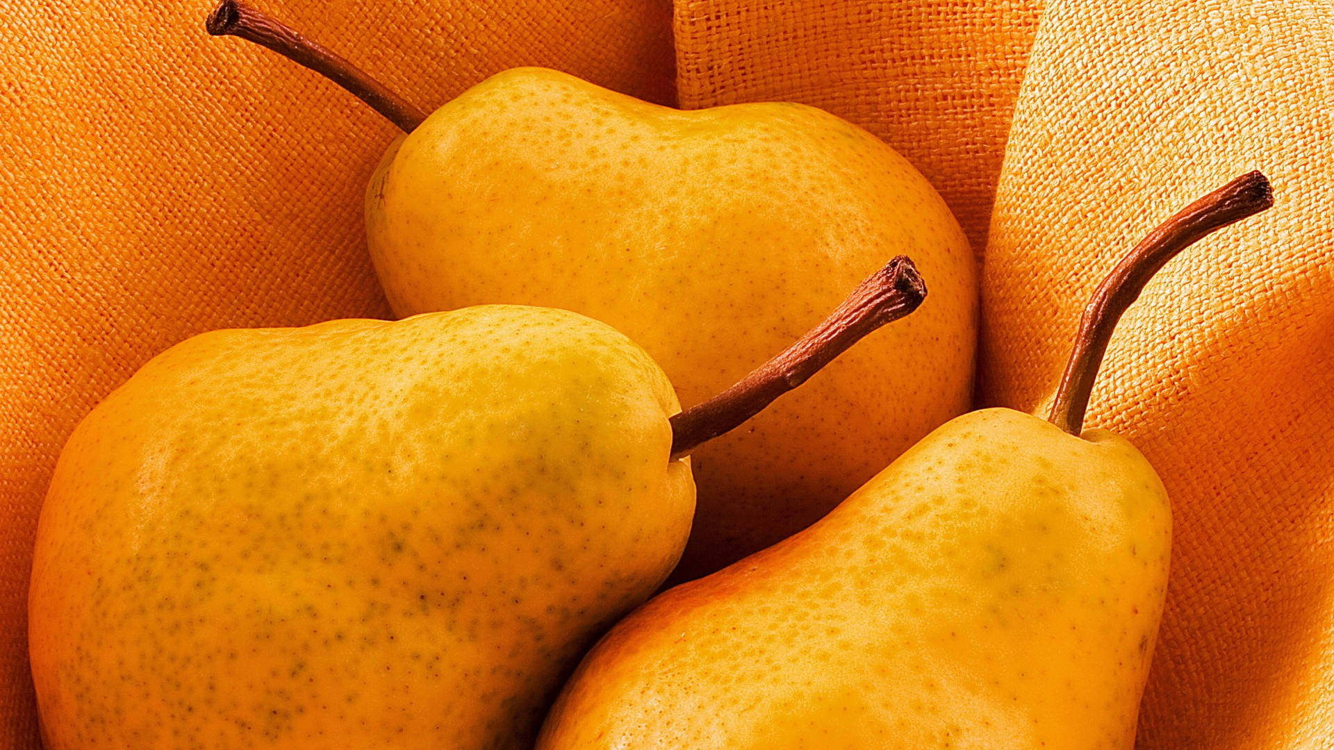 golden pears, brown stems, textured orange fabric, Full HD Desktop Wallpaper