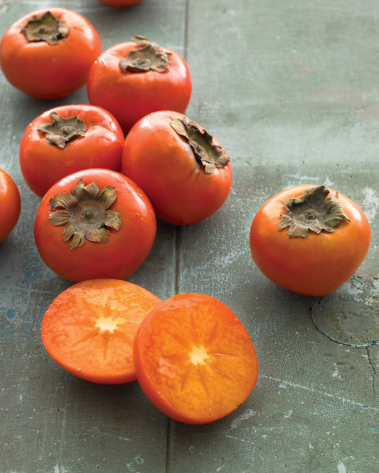 persimmon fruit, star-shaped calyxes, weathered green wooden surface, Full HD Phone Wallpaper