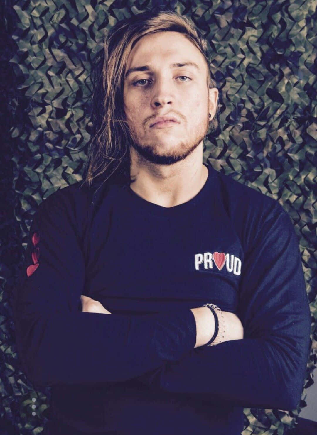 Pete Dunne, dark blue 'PROUD' shirt, textured green camouflage wall, HD Phone Wallpaper