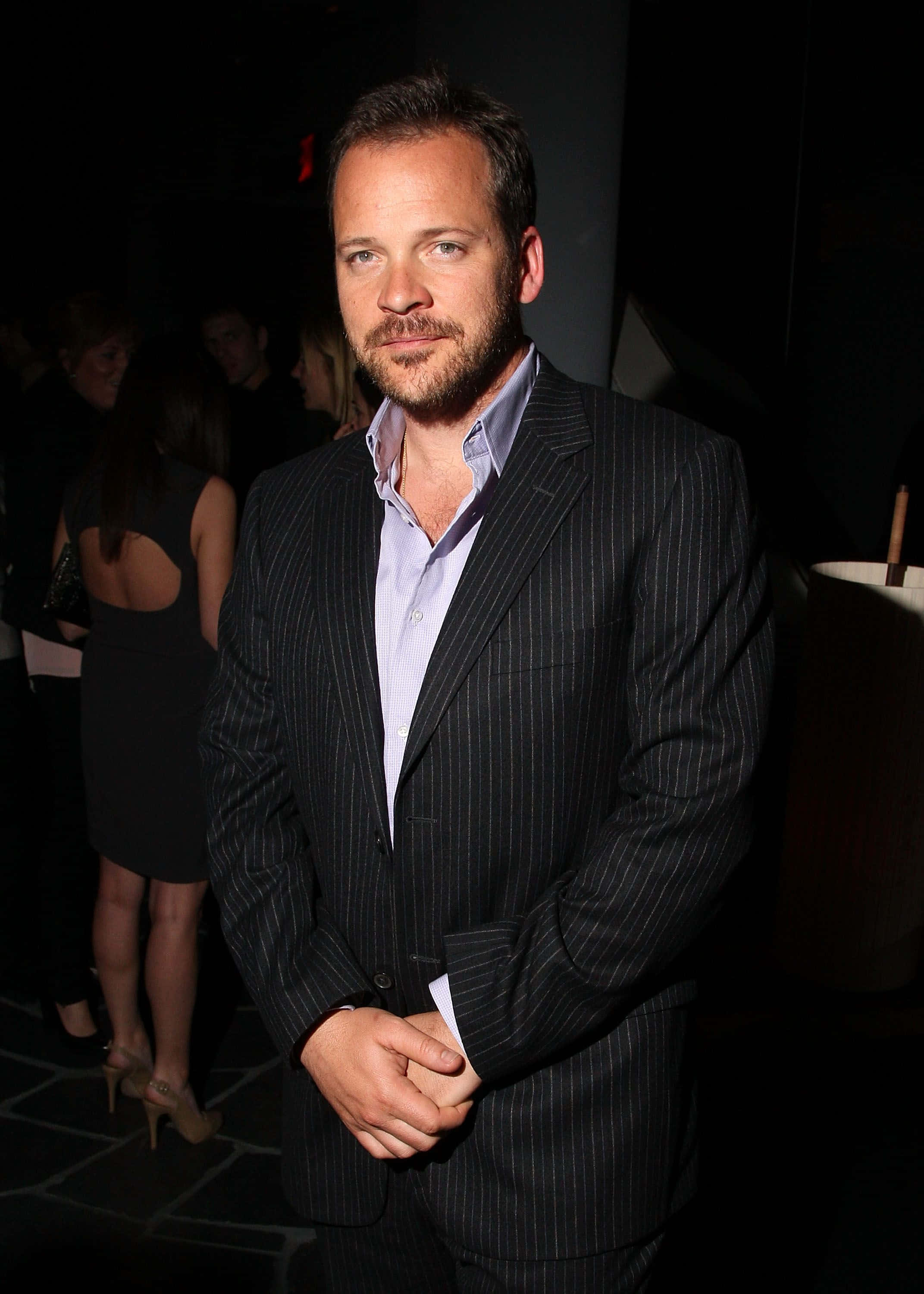 Peter Sarsgaard, pinstripe suit, dimly lit social gathering, 2K Phone Wallpaper
