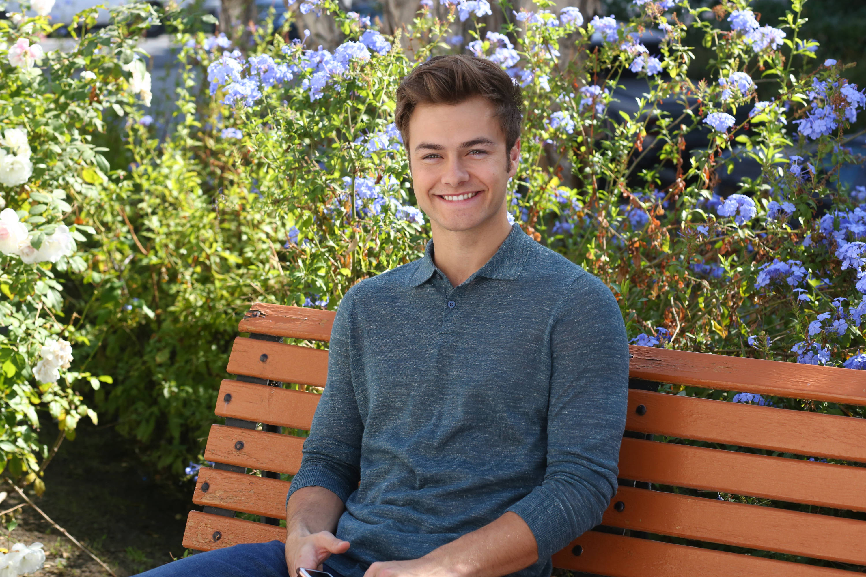 Peyton Meyer, blue shirt, wooden bench, 2K Desktop Wallpaper