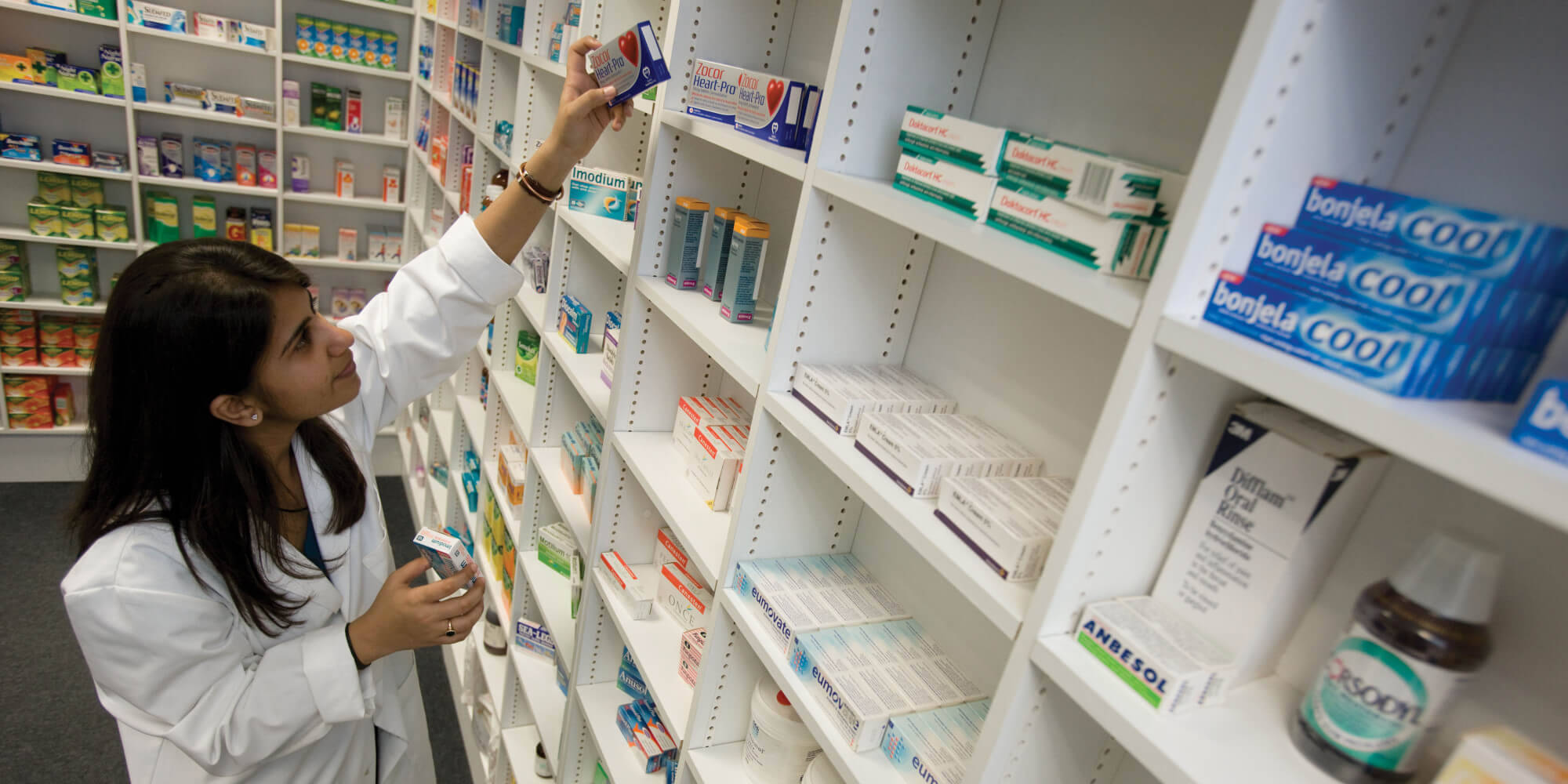female pharmacist, white coat, pharmacy shelf, Full HD Desktop Wallpaper