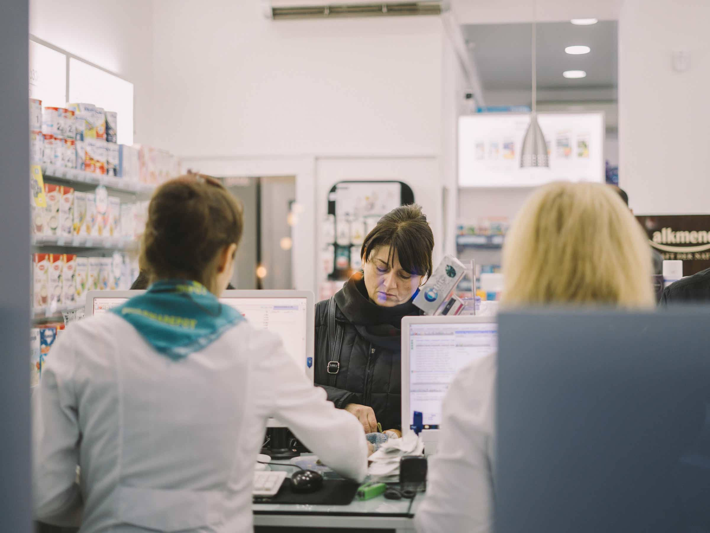 pharmacist, black jacket, well-lit pharmacy counter, Full HD Desktop Wallpaper