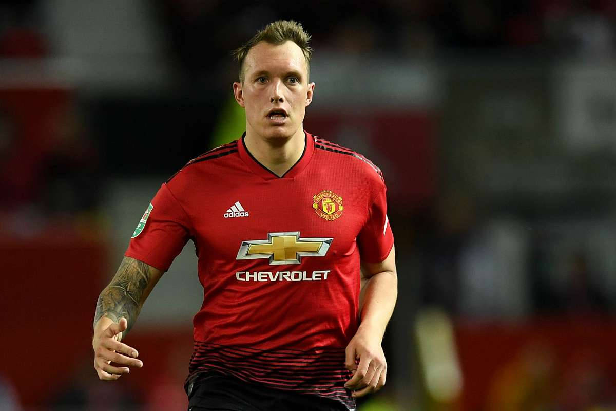 Phil Jones, red Manchester United jersey, blurred stadium, SD Desktop Wallpaper