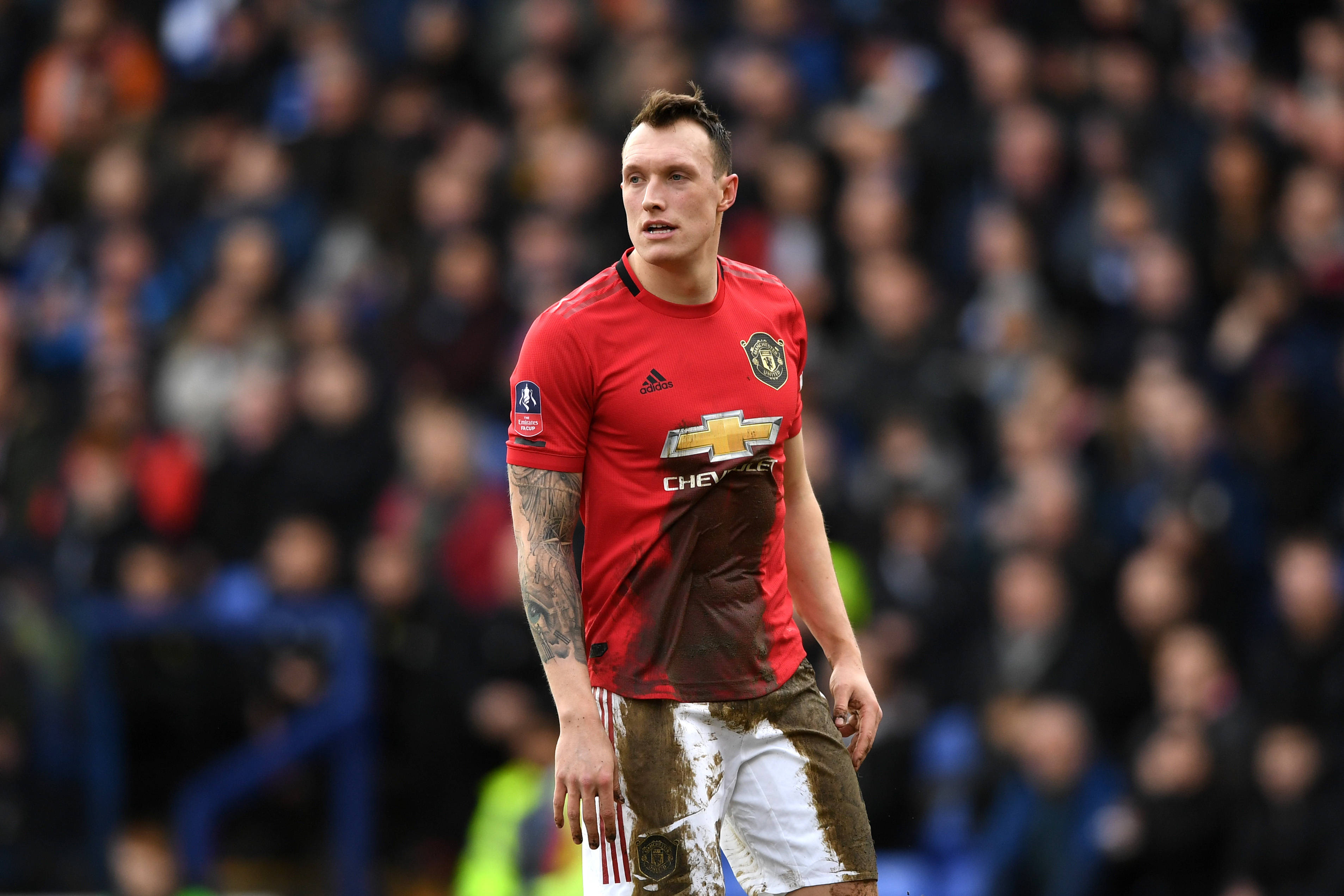 Phil Jones, red Manchester United jersey, rainy pitch, 2K Desktop Wallpaper