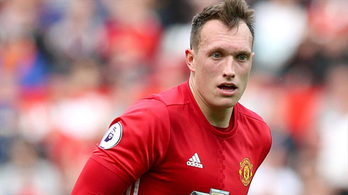 Phil Jones, red Manchester United jersey, daytime match, SD Desktop Wallpaper