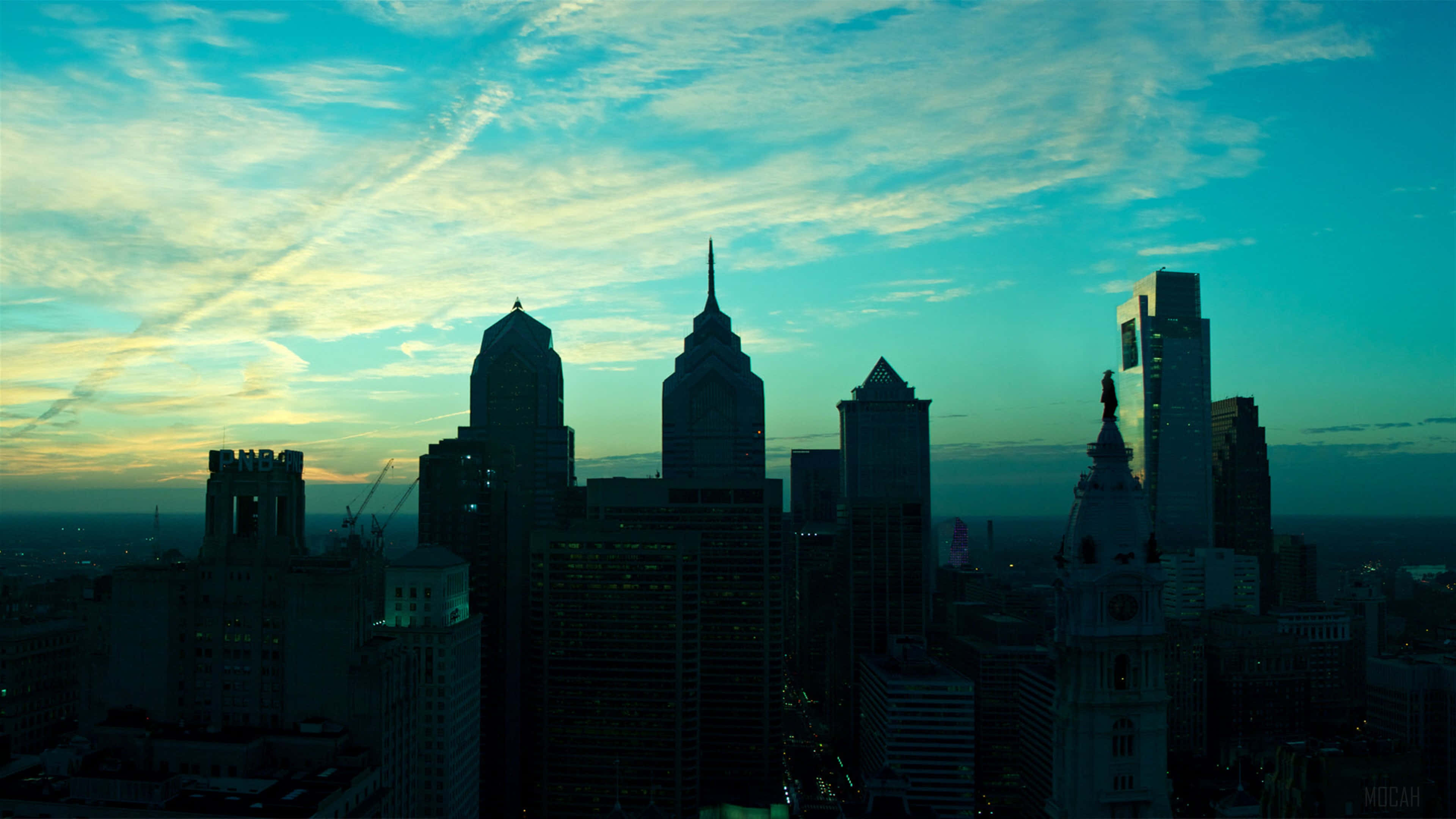 Philadelphia skyline, silhouetted buildings, teal and gold sunset sky, 4K Desktop Wallpaper