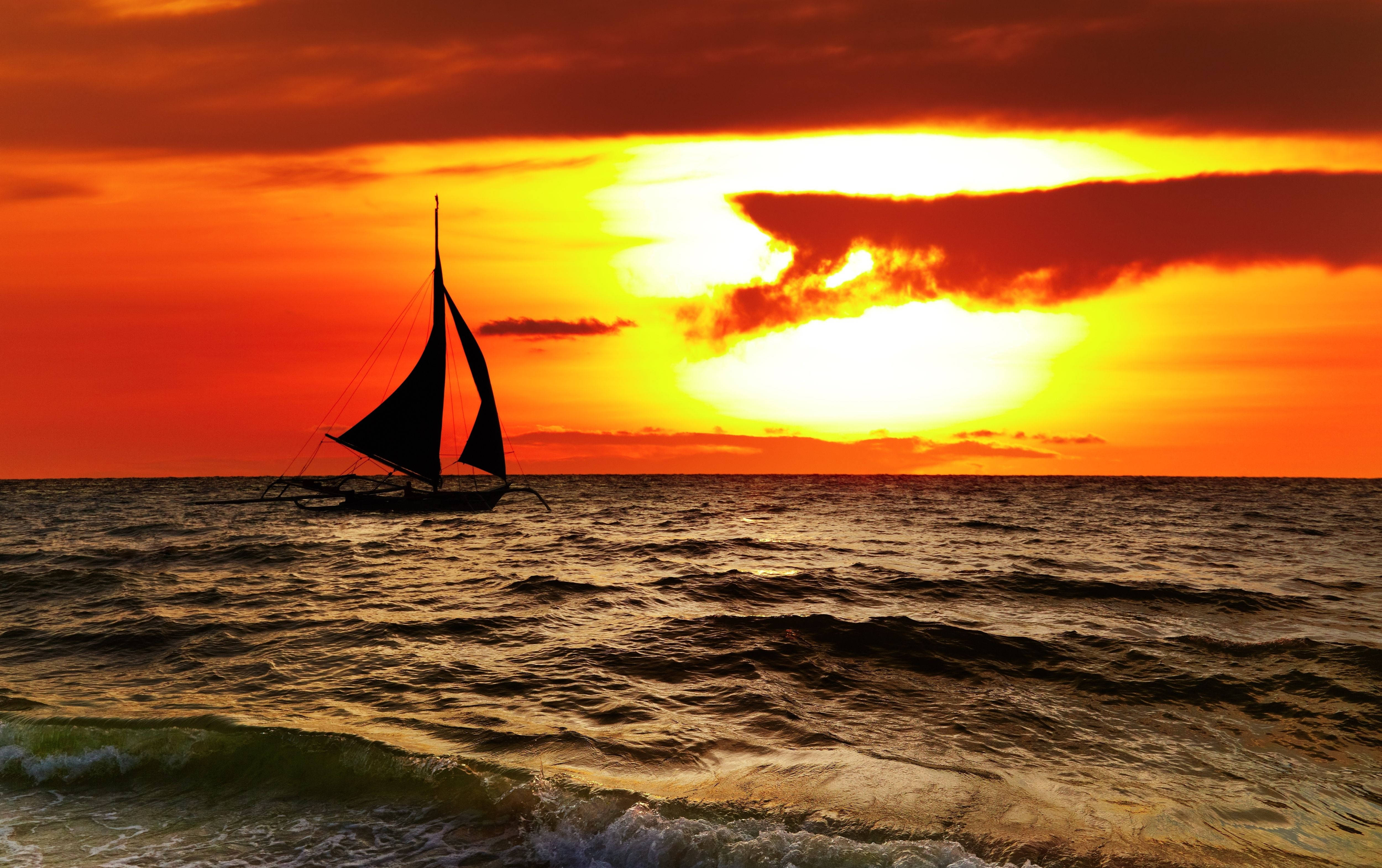 sailboat silhouette, vibrant orange and red sunset, textured ocean, 4K Desktop Wallpaper