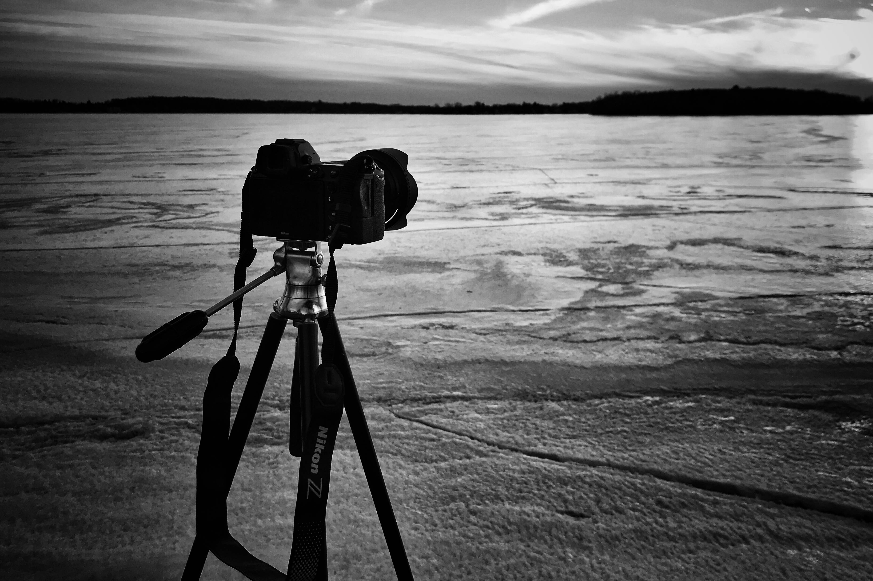 black and white camera, tripod, cracked frozen lake, 2K Desktop Wallpaper