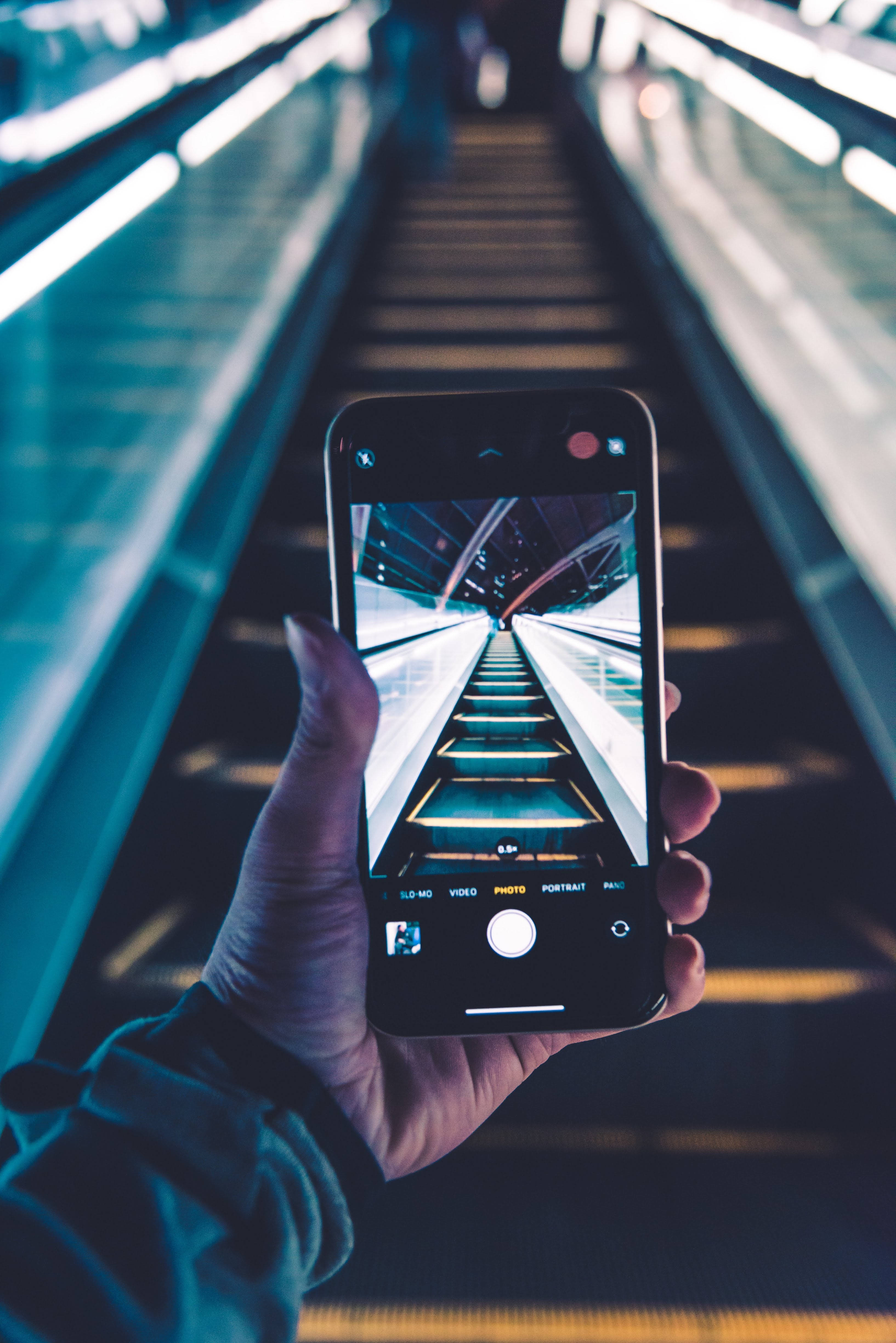 smartphone, modern escalator, cool blue lighting, 4K Phone Wallpaper
