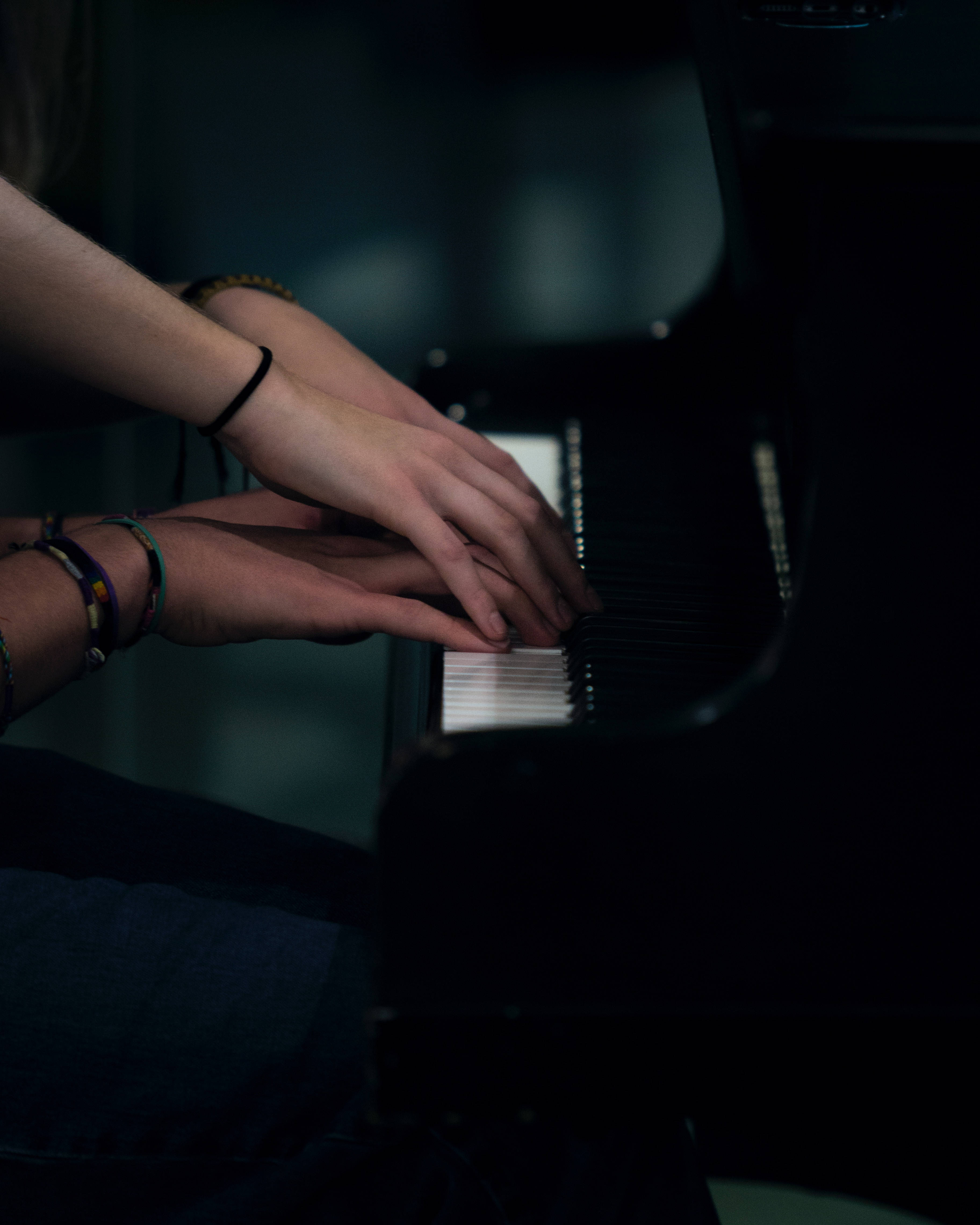 Piano, hands, dim blue-lit room, 4K Phone Wallpaper