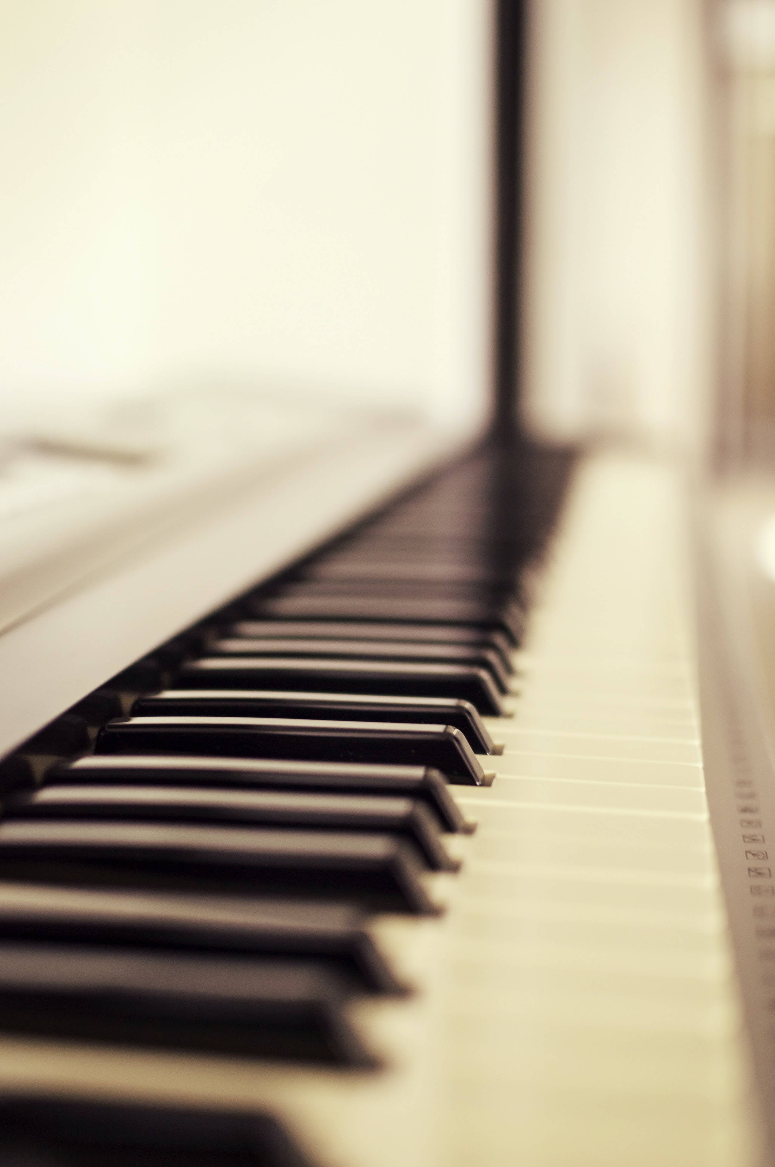 piano keys, warm sepia tones, soft focus background, 4K Phone Wallpaper