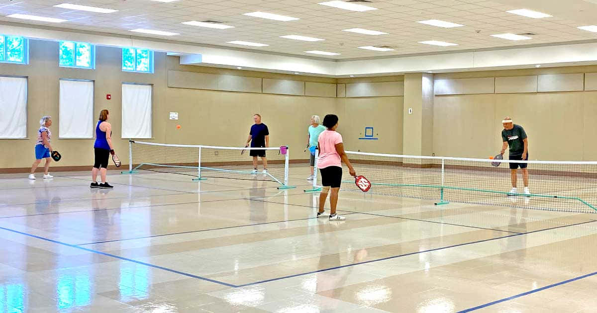 indoor pickleball session, polished court, bright fluorescent lights, SD Desktop Wallpaper