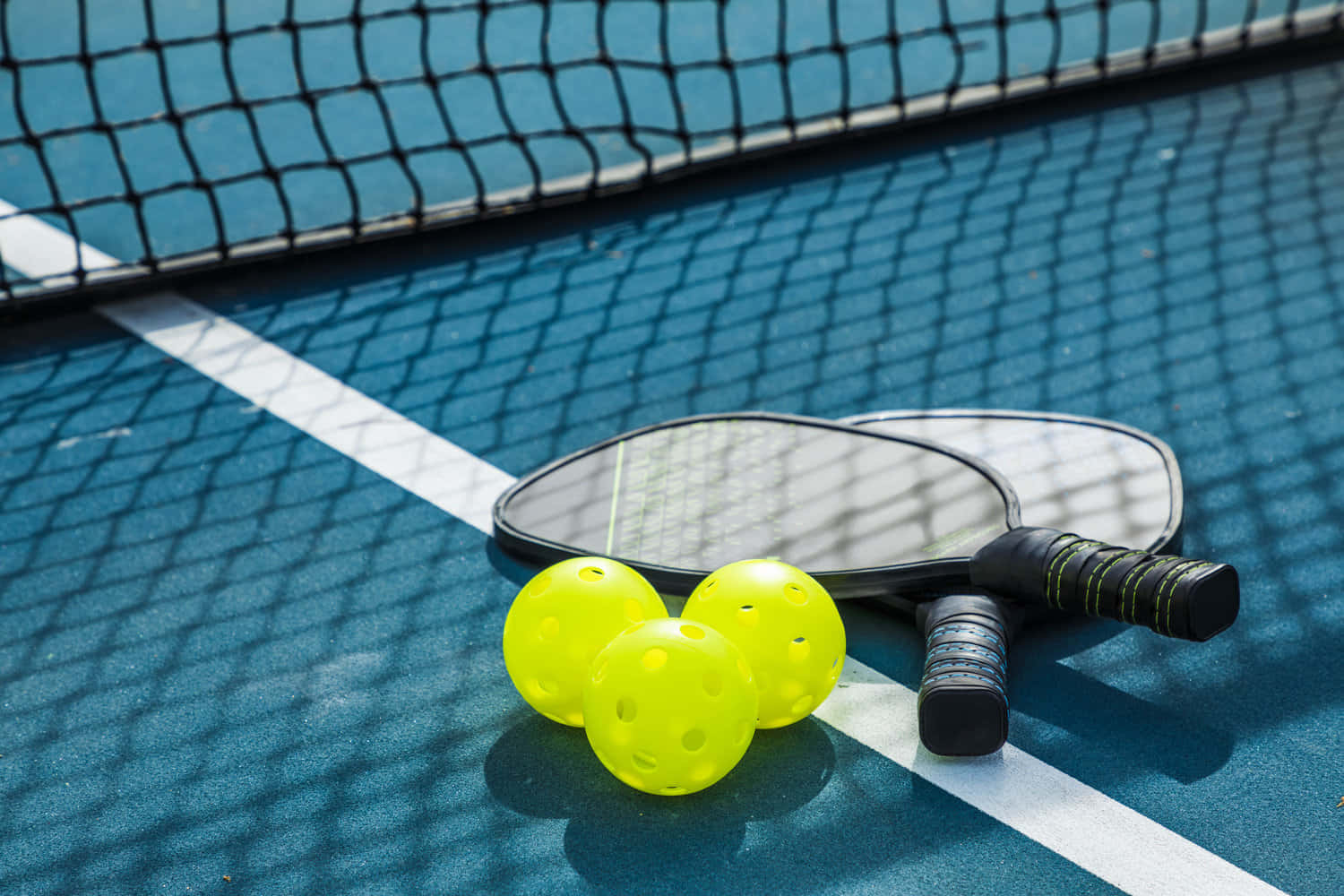 pickleball paddles, bright yellow balls, blue court, HD Desktop Wallpaper