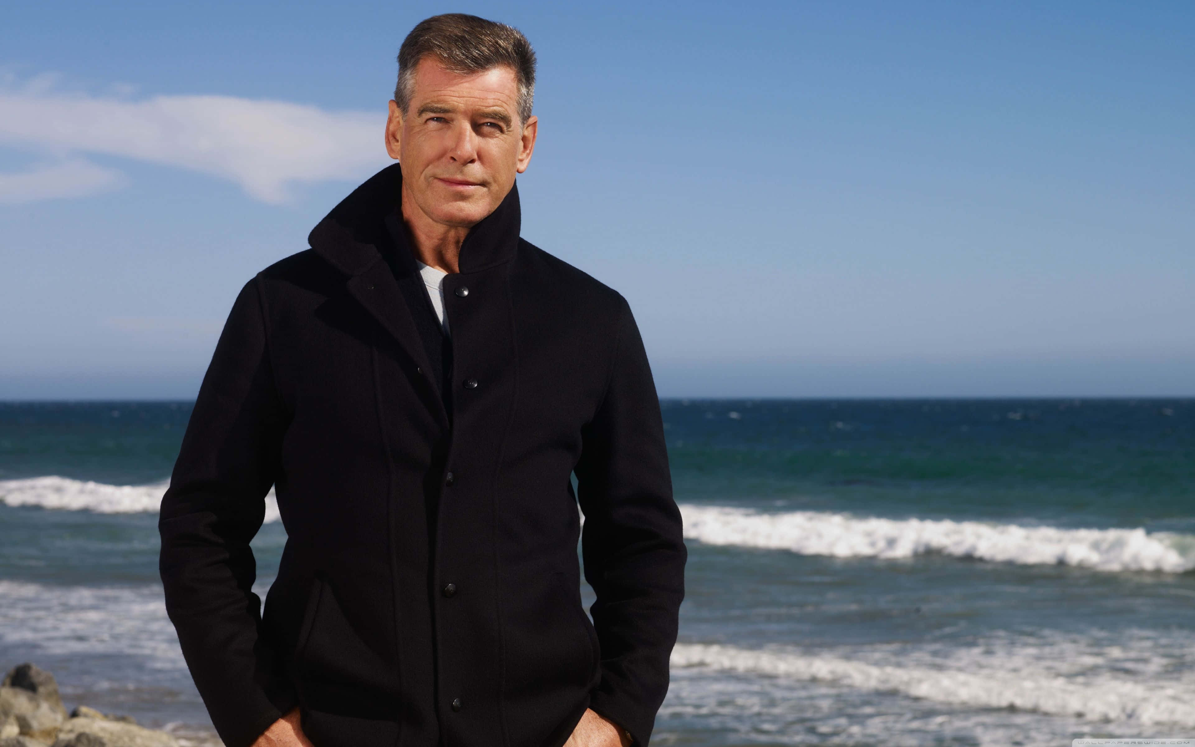 Pierce Brosnan, black coat, rocky beach, 4K Desktop Wallpaper